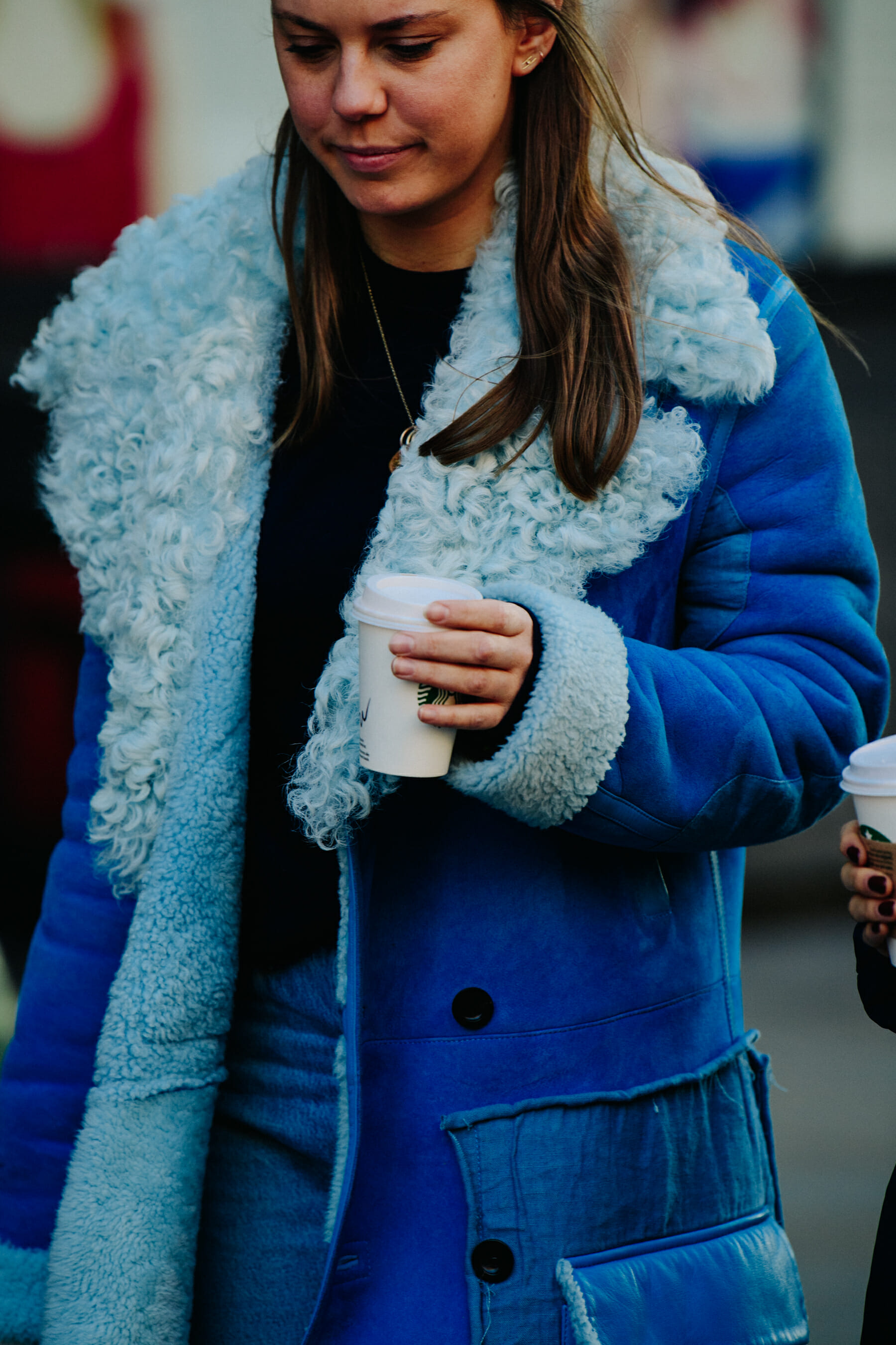 Woman wearing blue fur coat