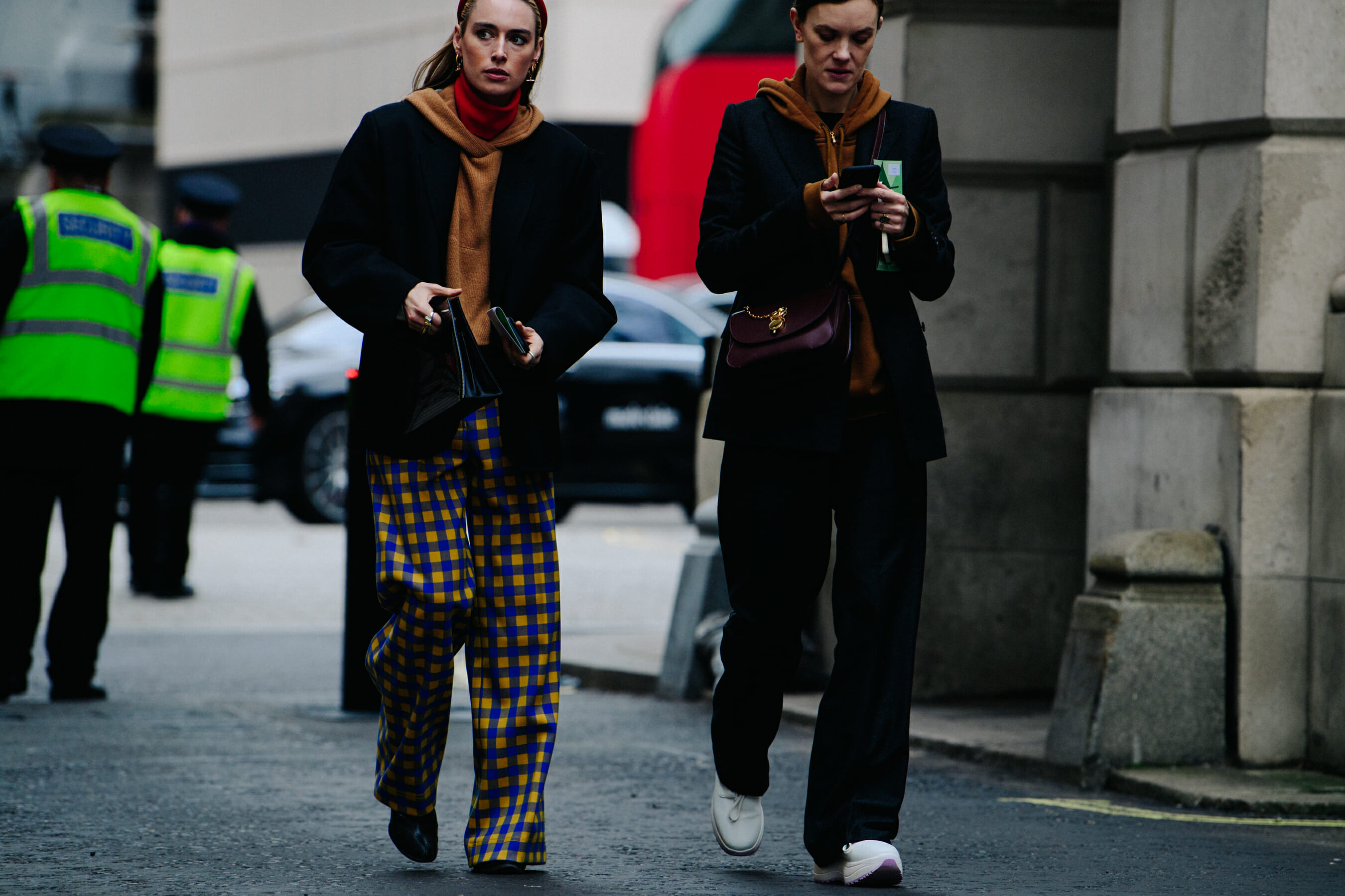 Two women wearing orange hoodies