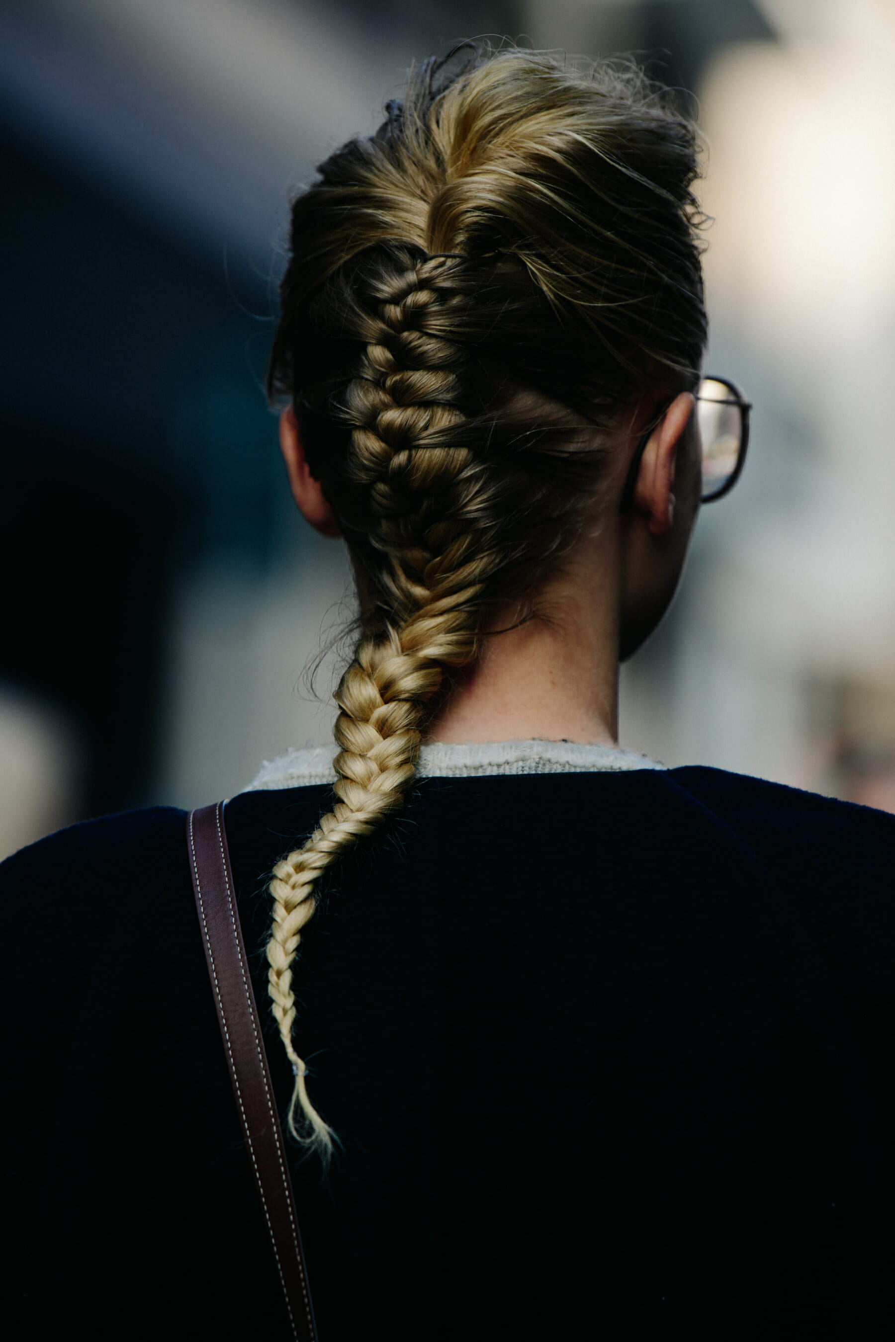 Model wearing long blonde plait