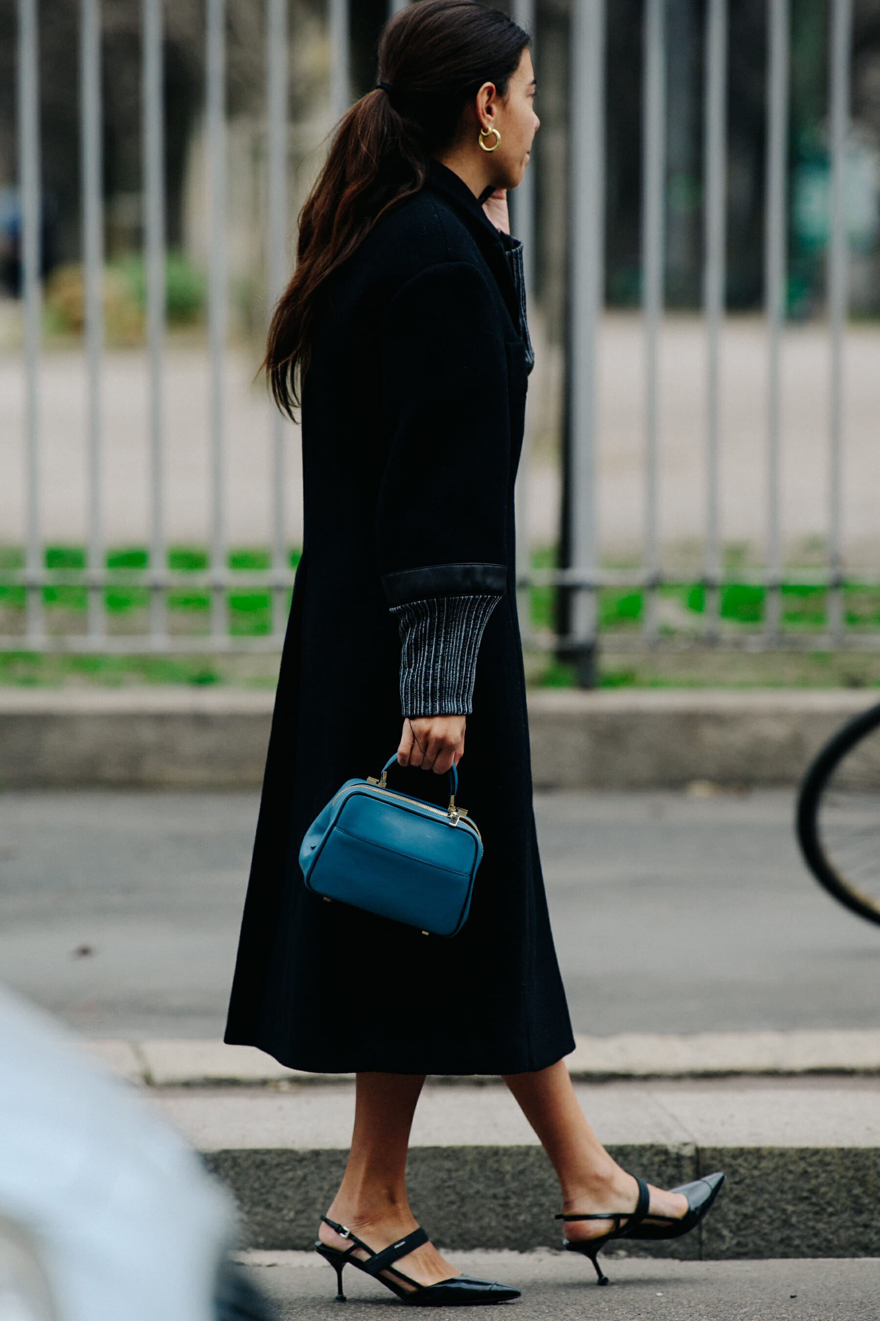 Woman carrying blue leather bag