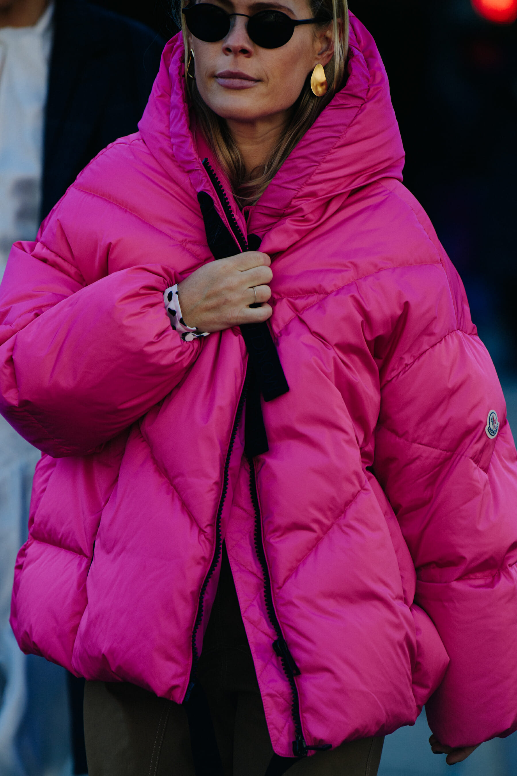 Woman wearing pink Moncler coat
