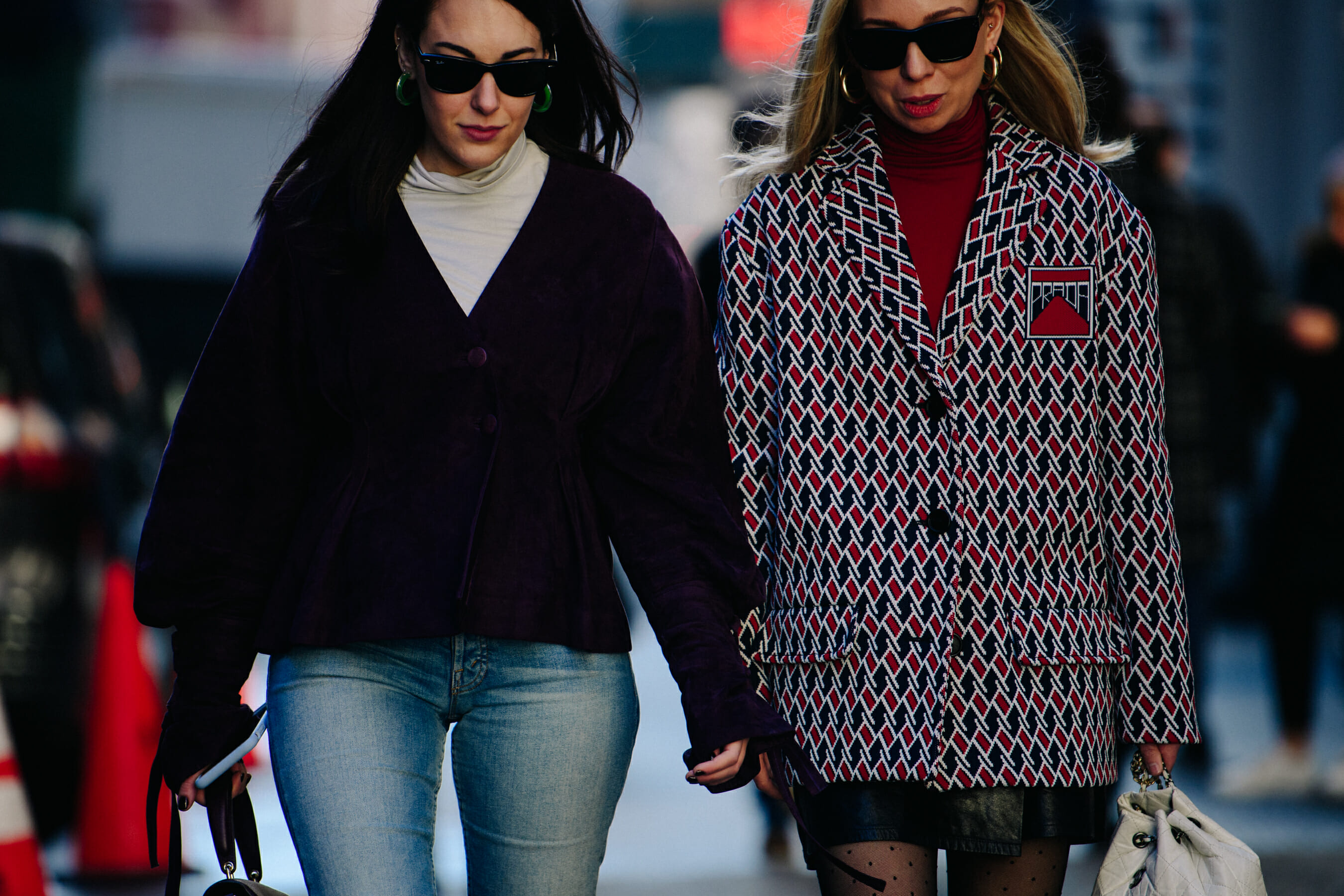 Two women wearing light formal jackets