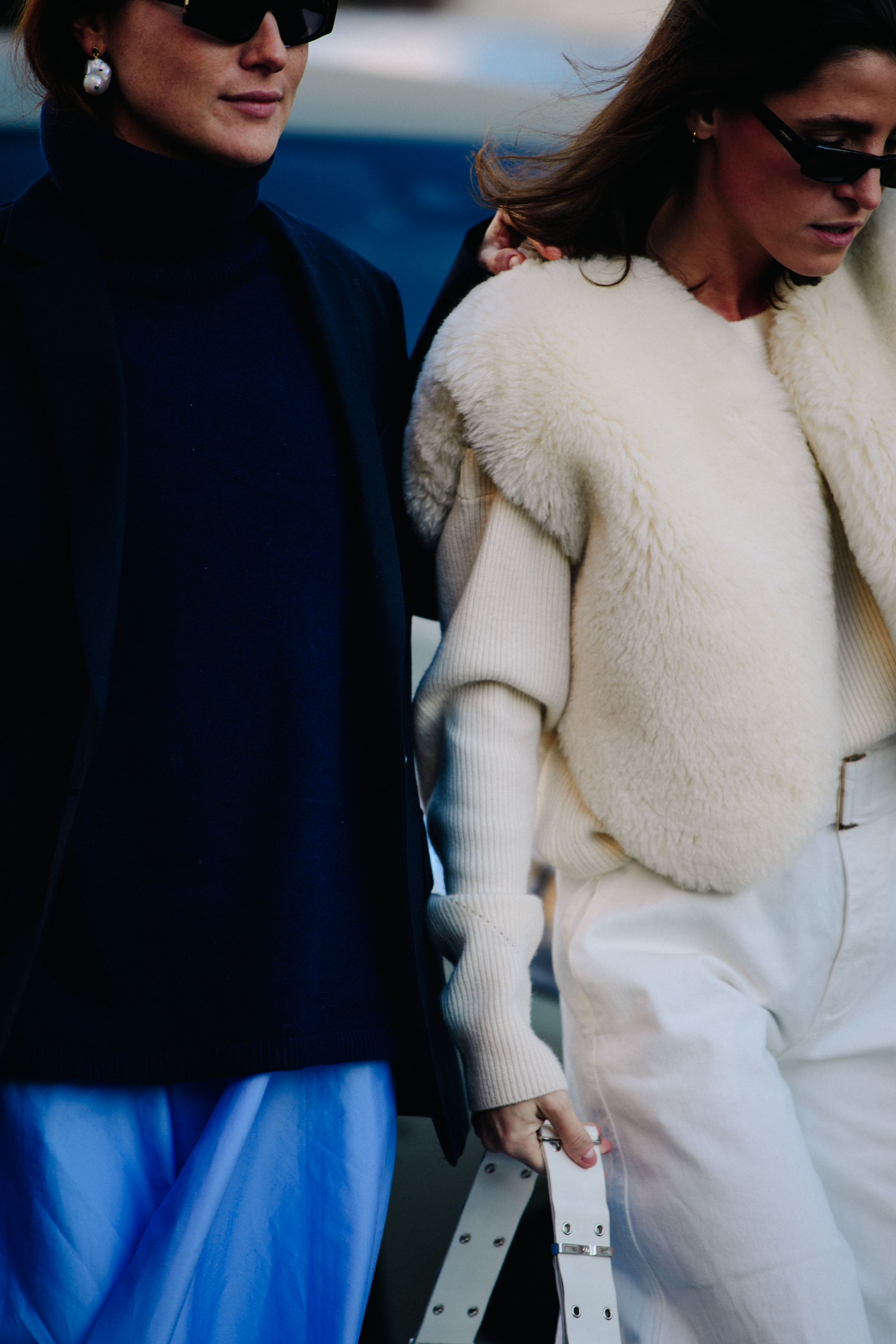 Two women wearing dark and light clothing