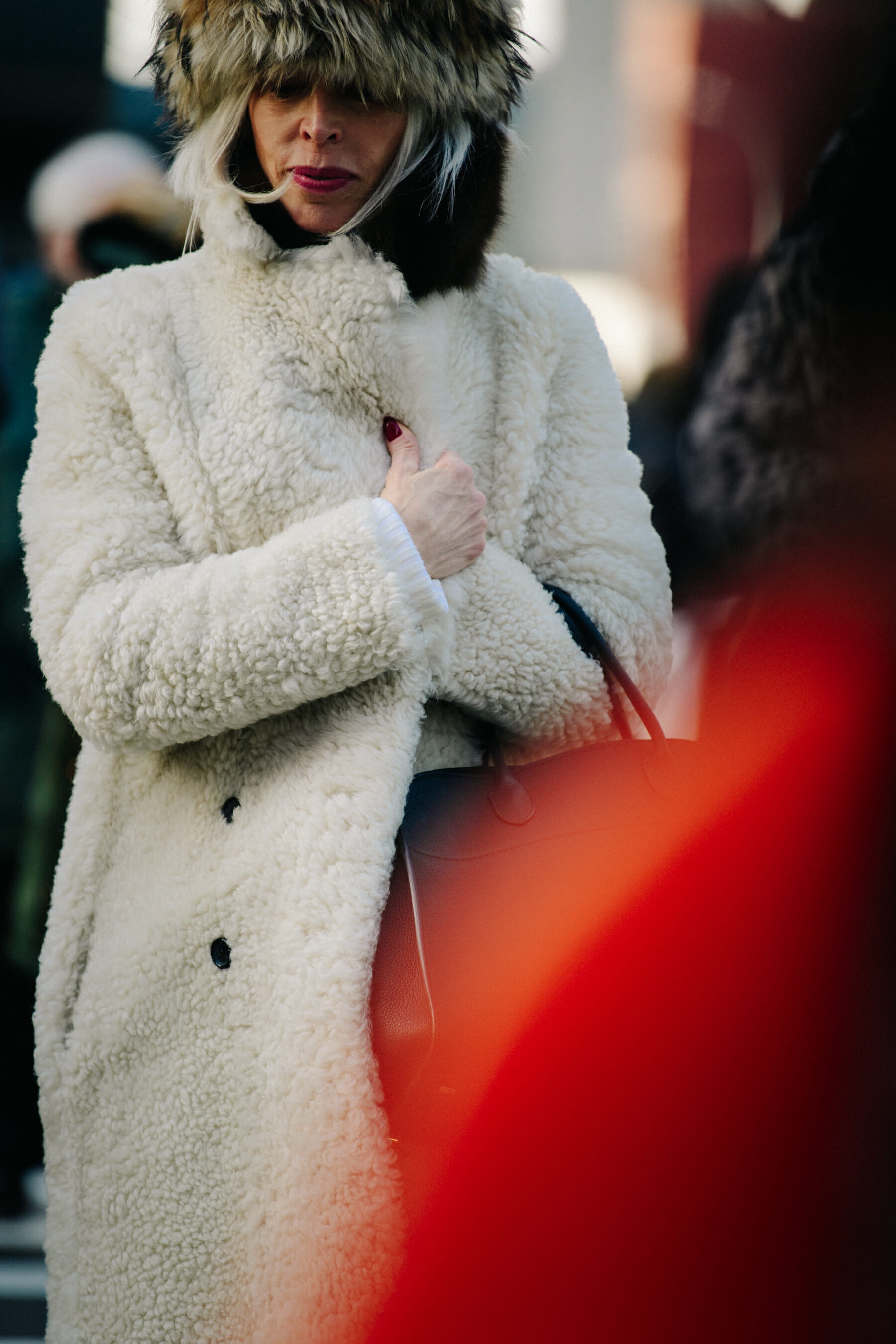 Woman wearing white fur coat