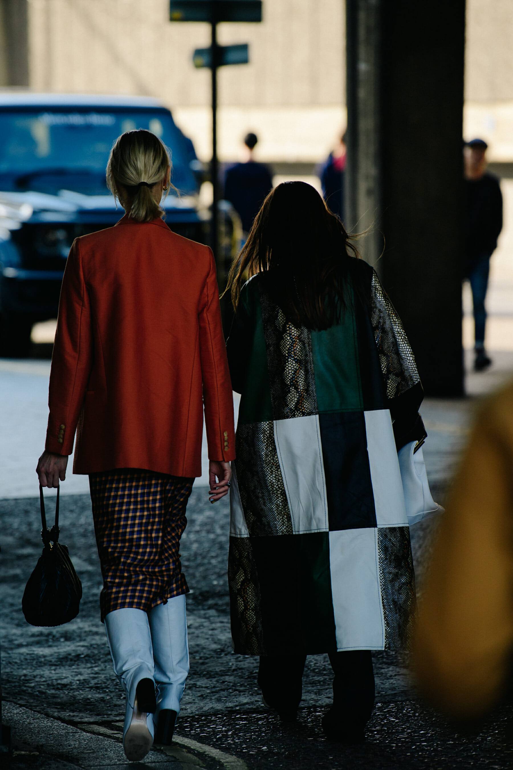 Two women wearing green and orange