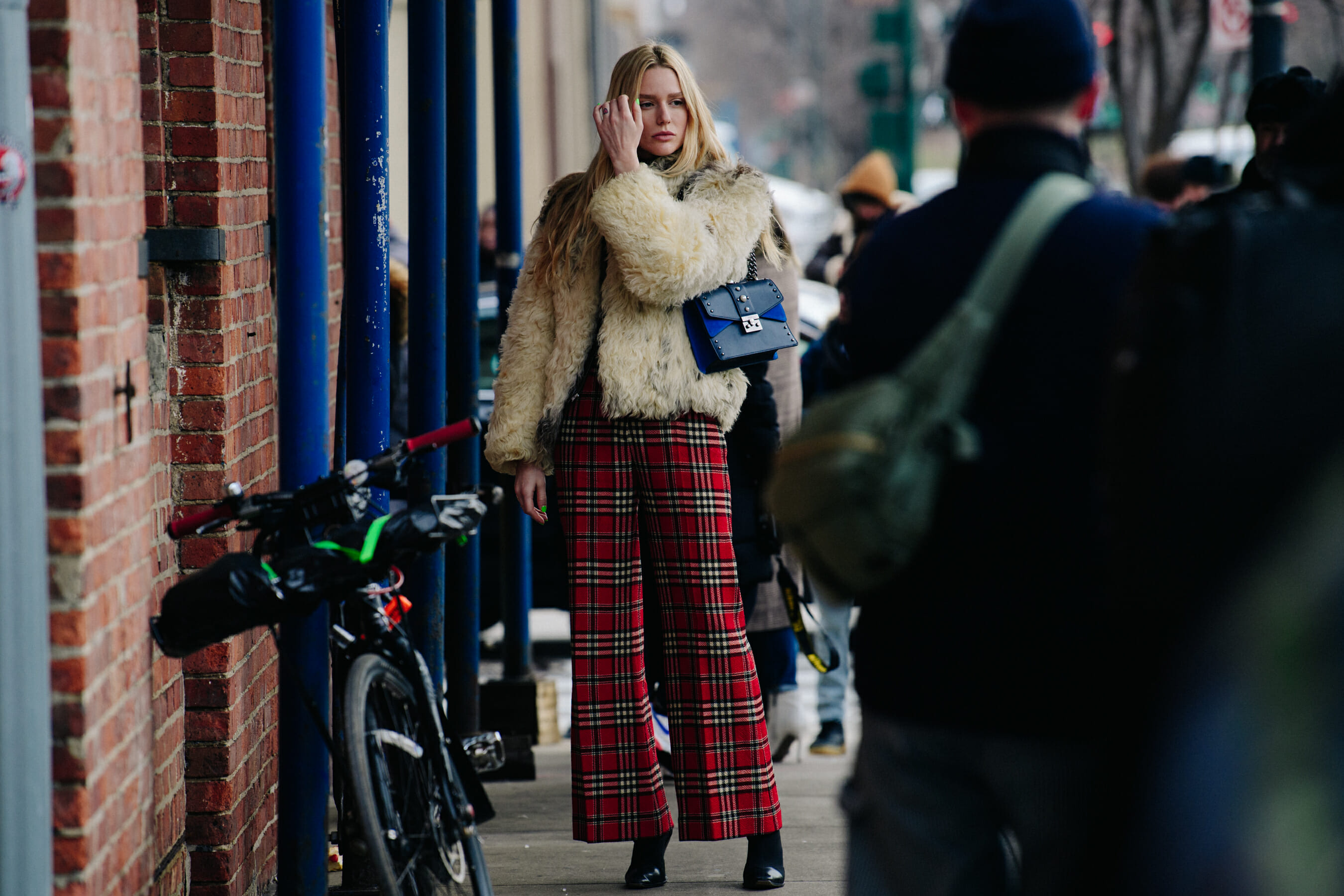 Woman wearing red tartan pants