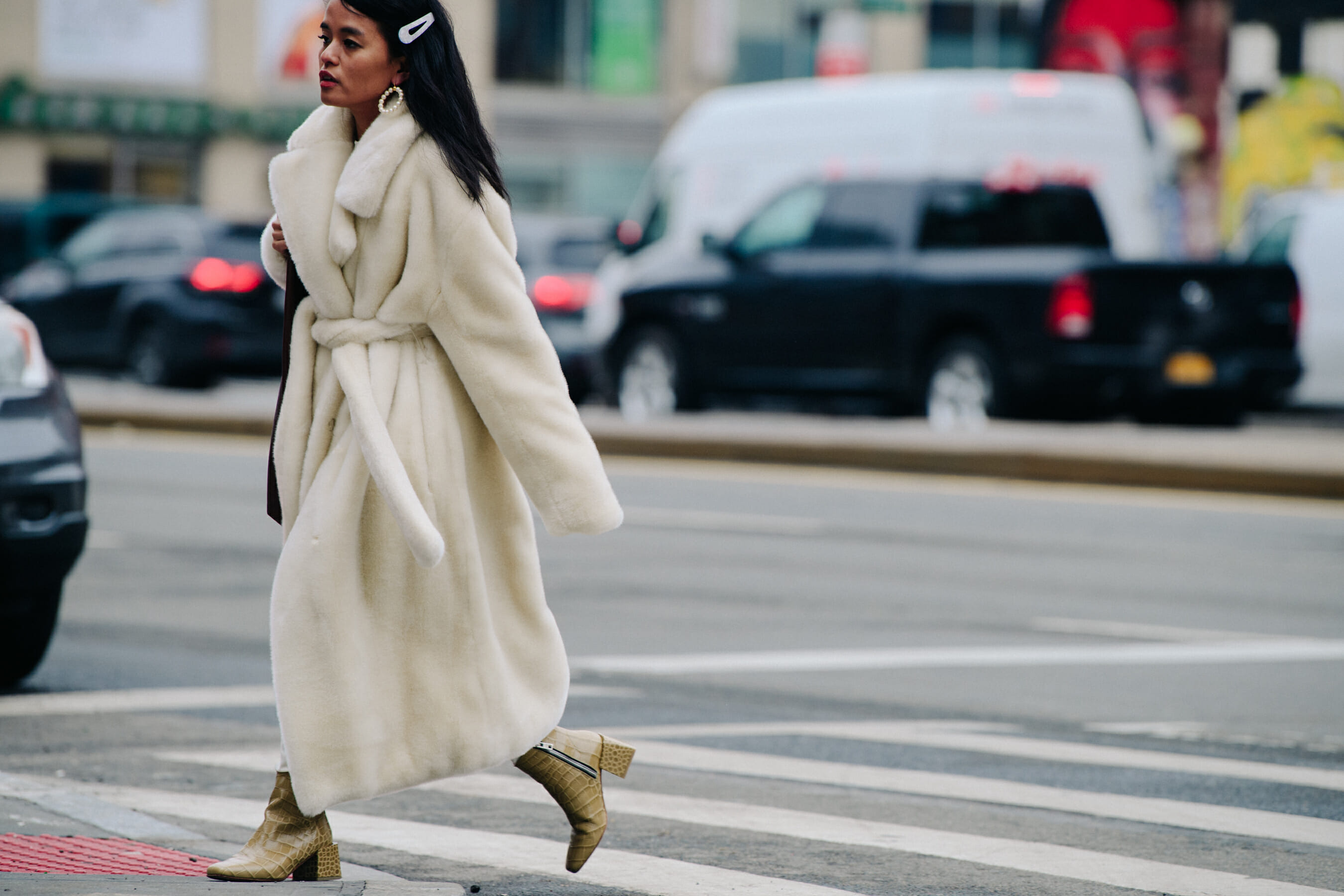Woman wearing white fur coat