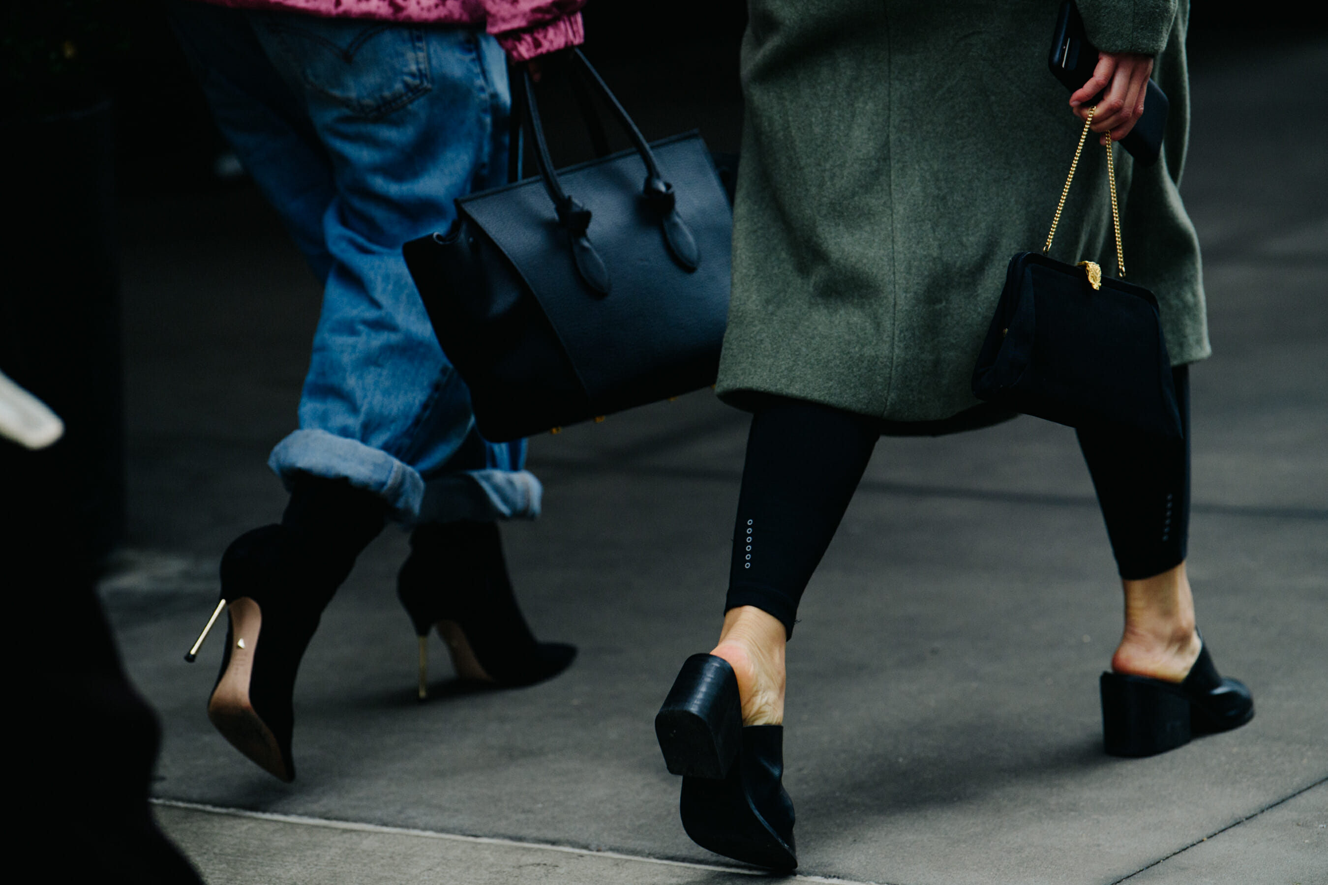 Two women wearing black shoes