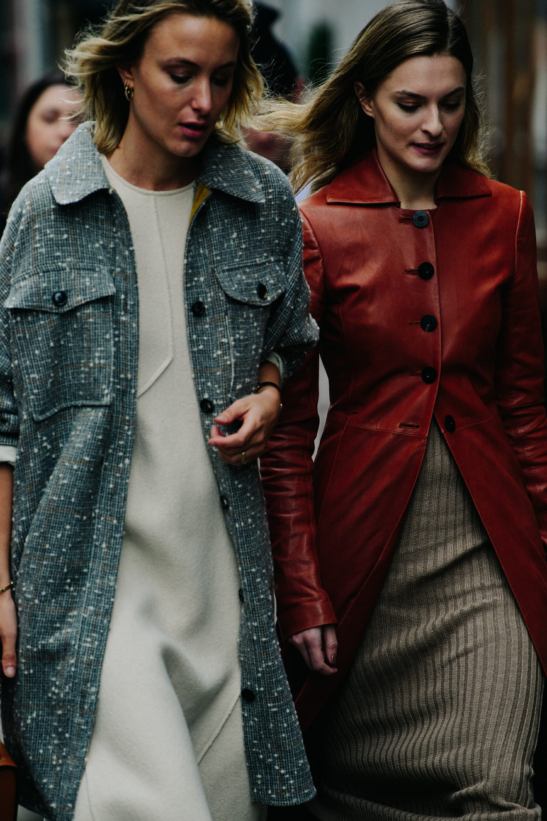 Two women wearing long coats