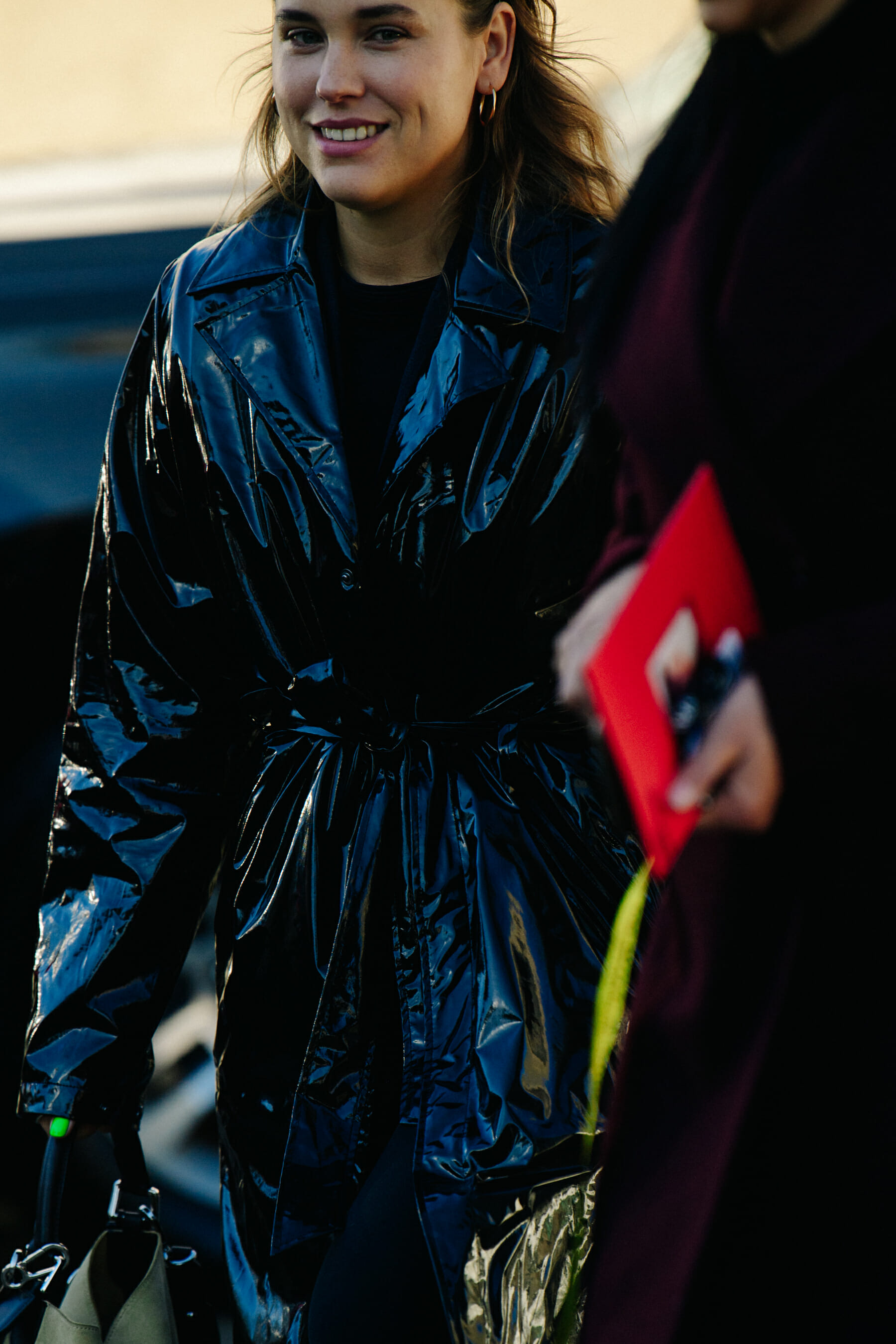 Woman wearing black plastic coat