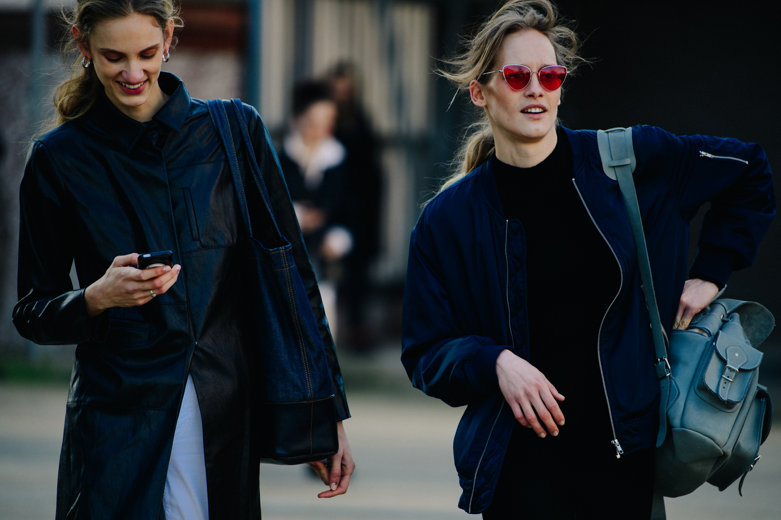 Two models wearing dark outfits