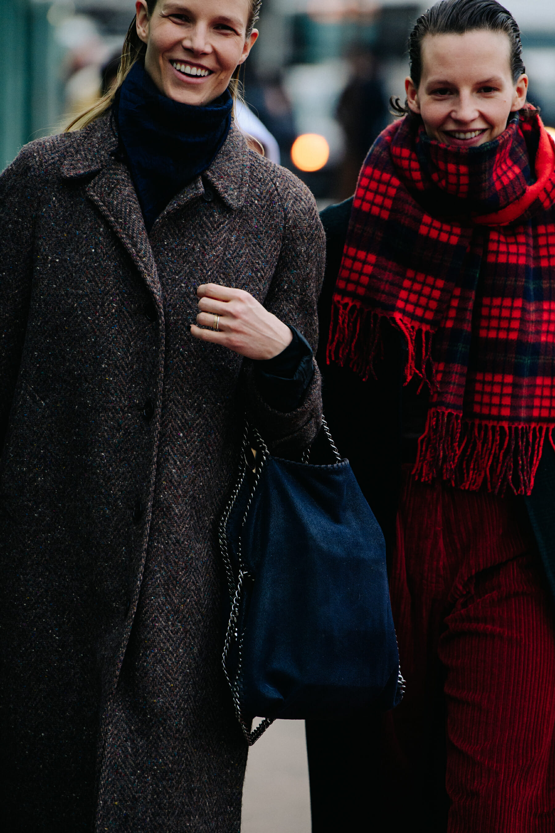 Two models wearing long coats