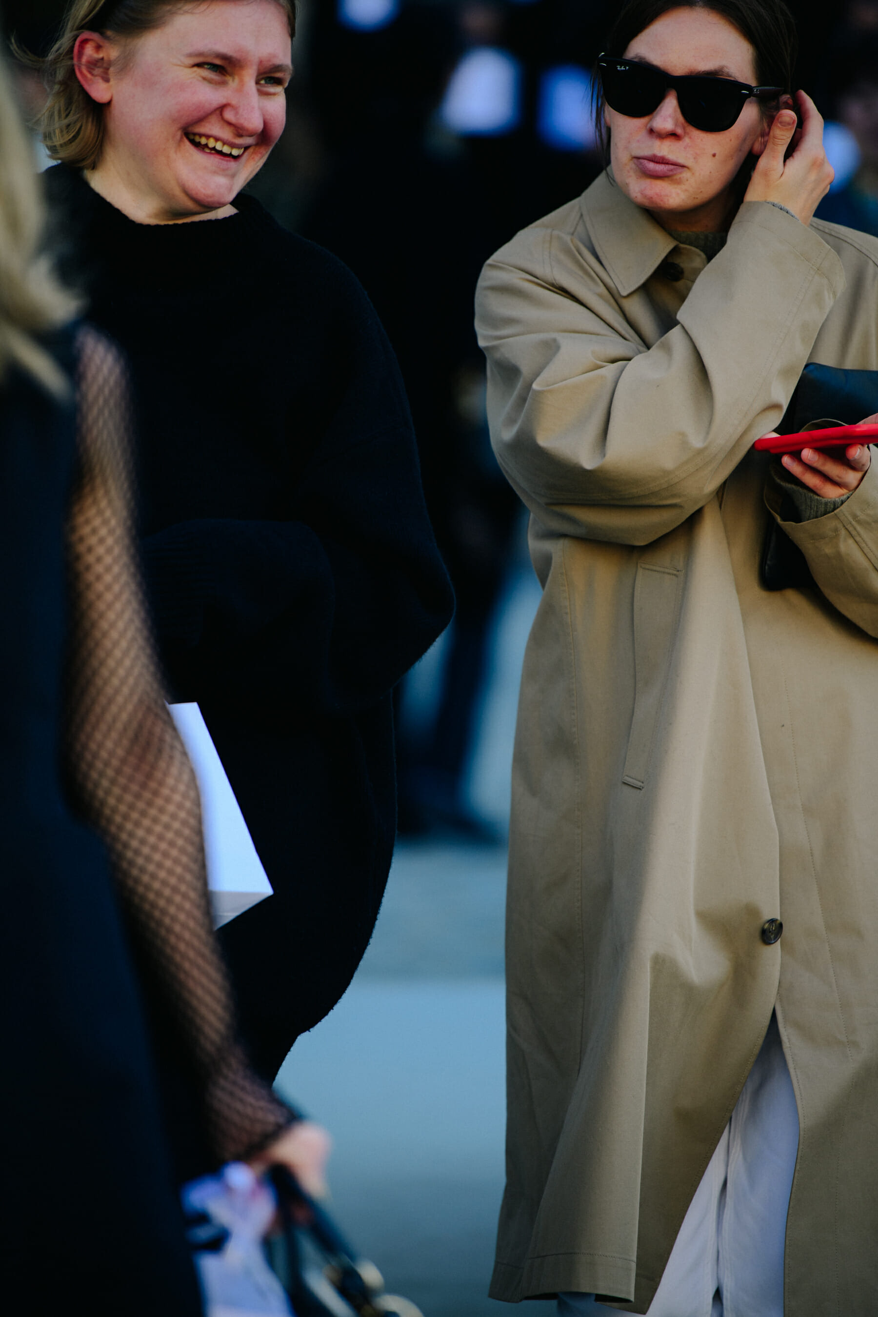 Two women wearing long coats