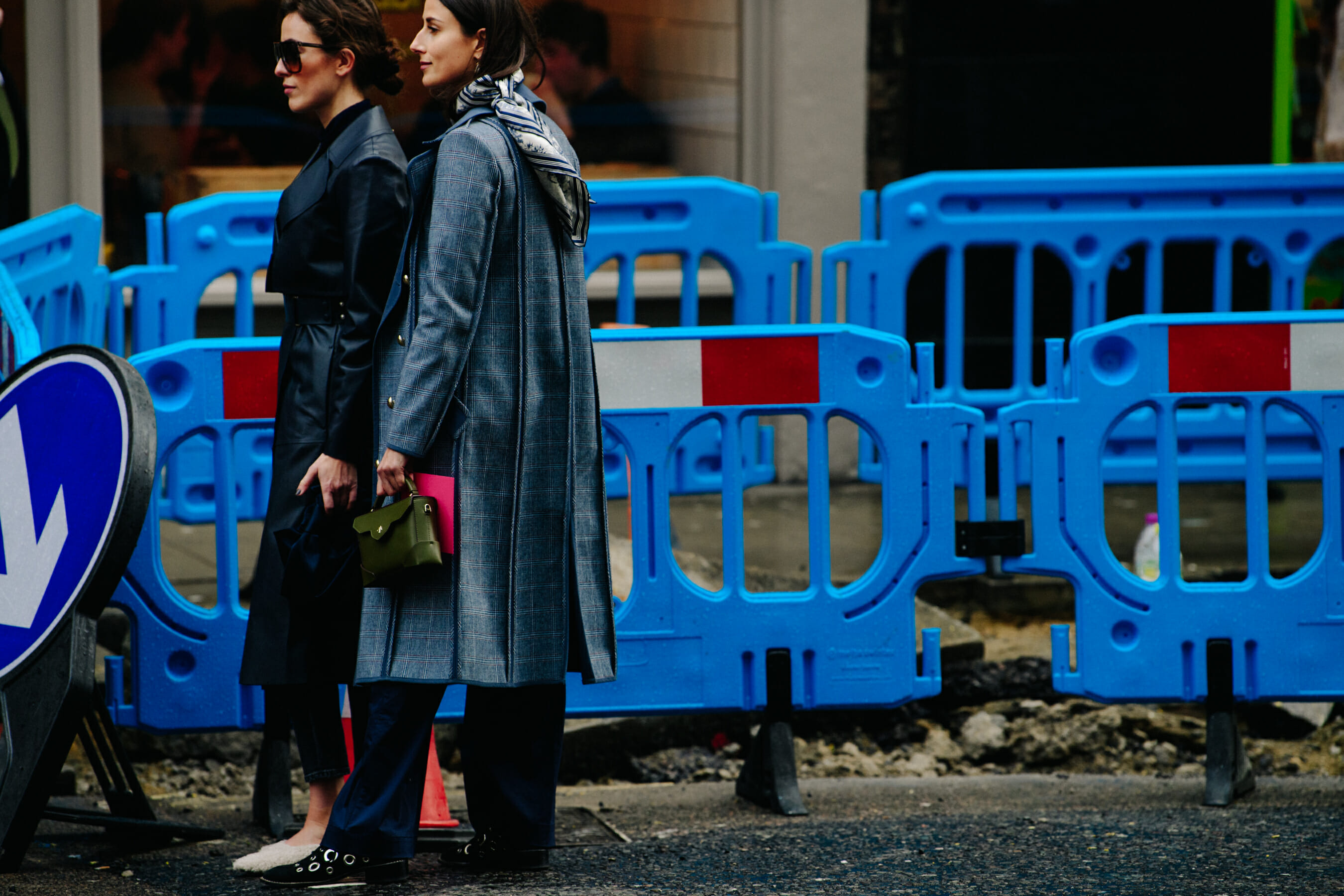 Two women wearing long coats