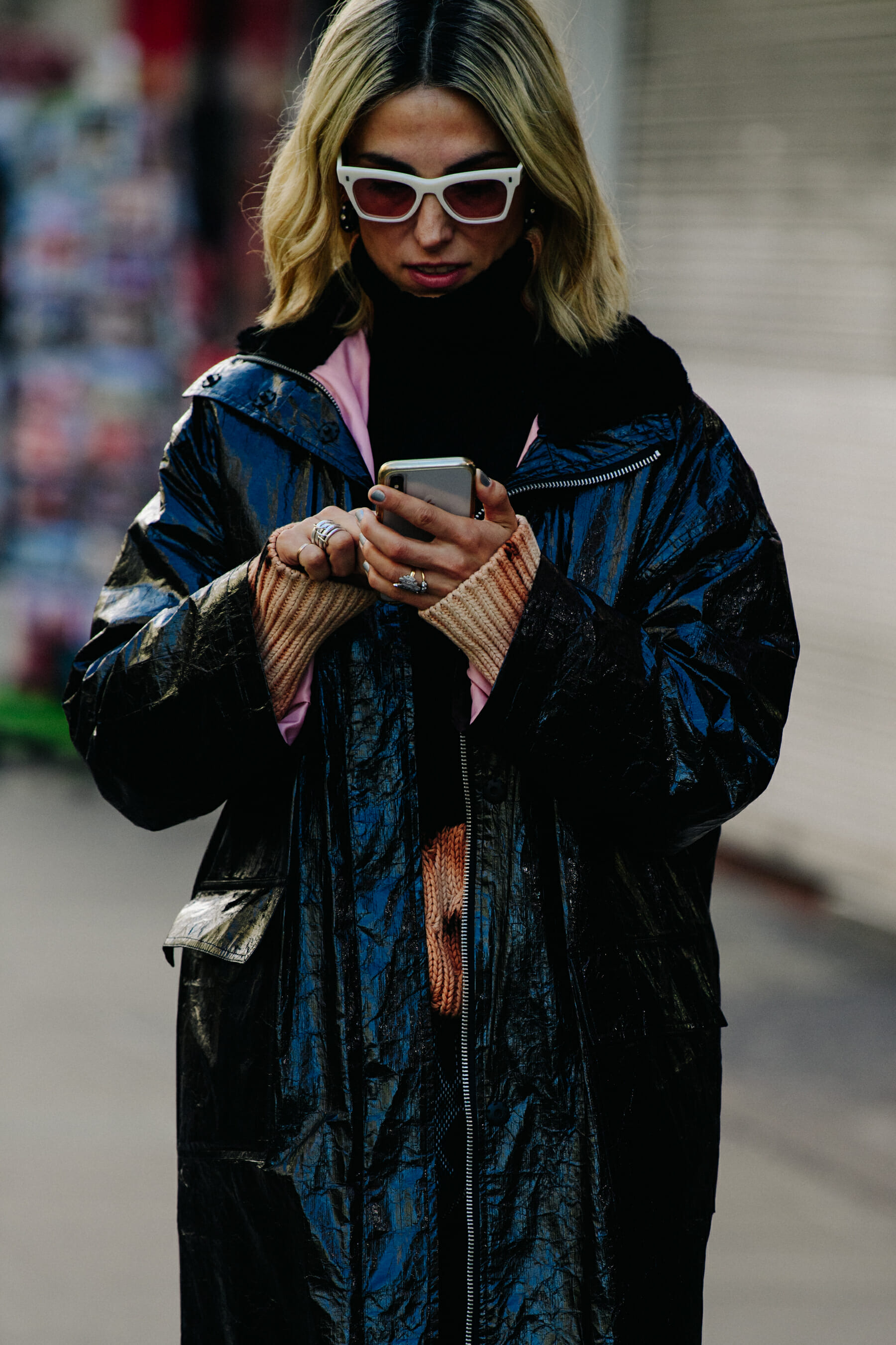 Greek woman wearing black patent coat