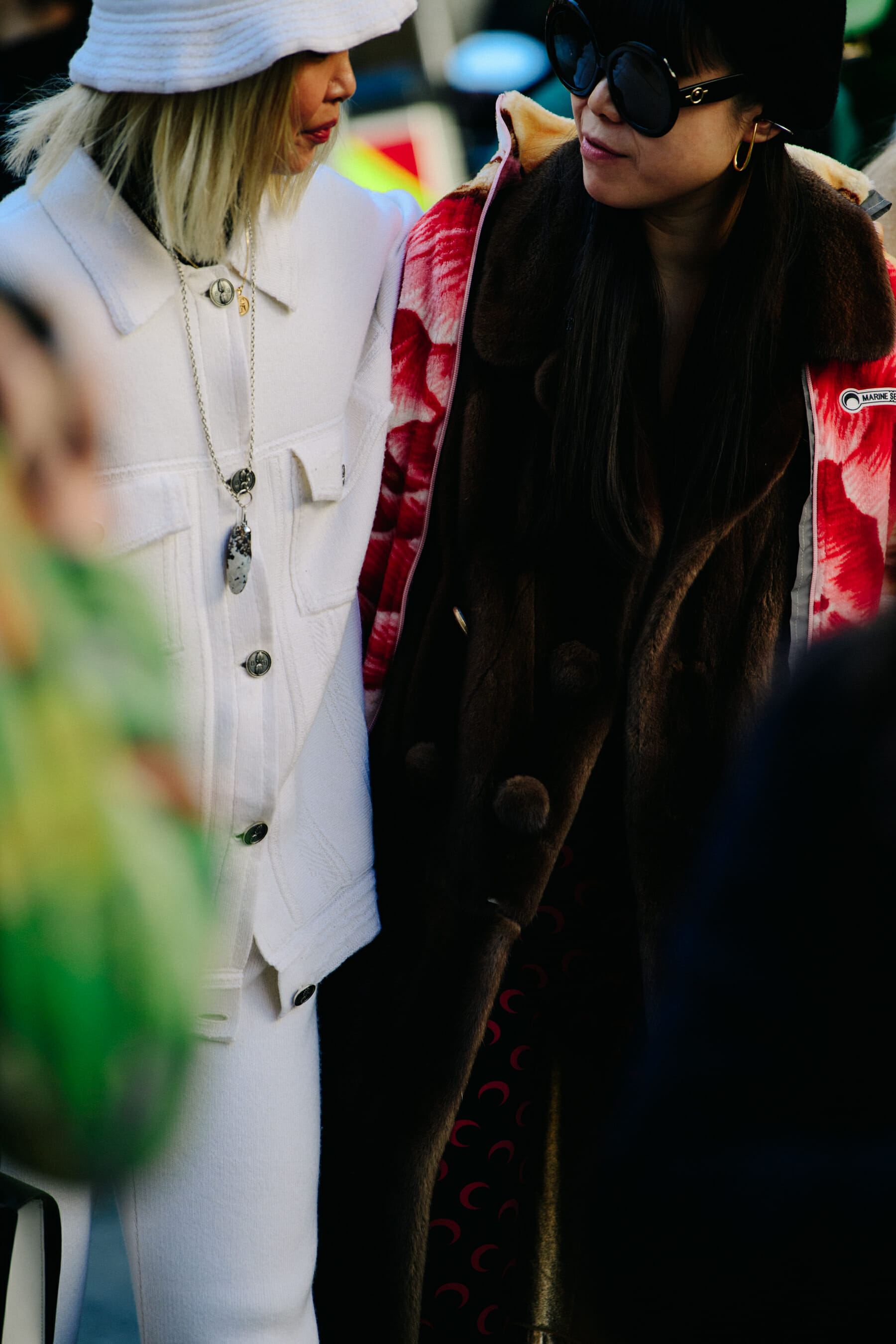 Two women wearing fashionable outfits