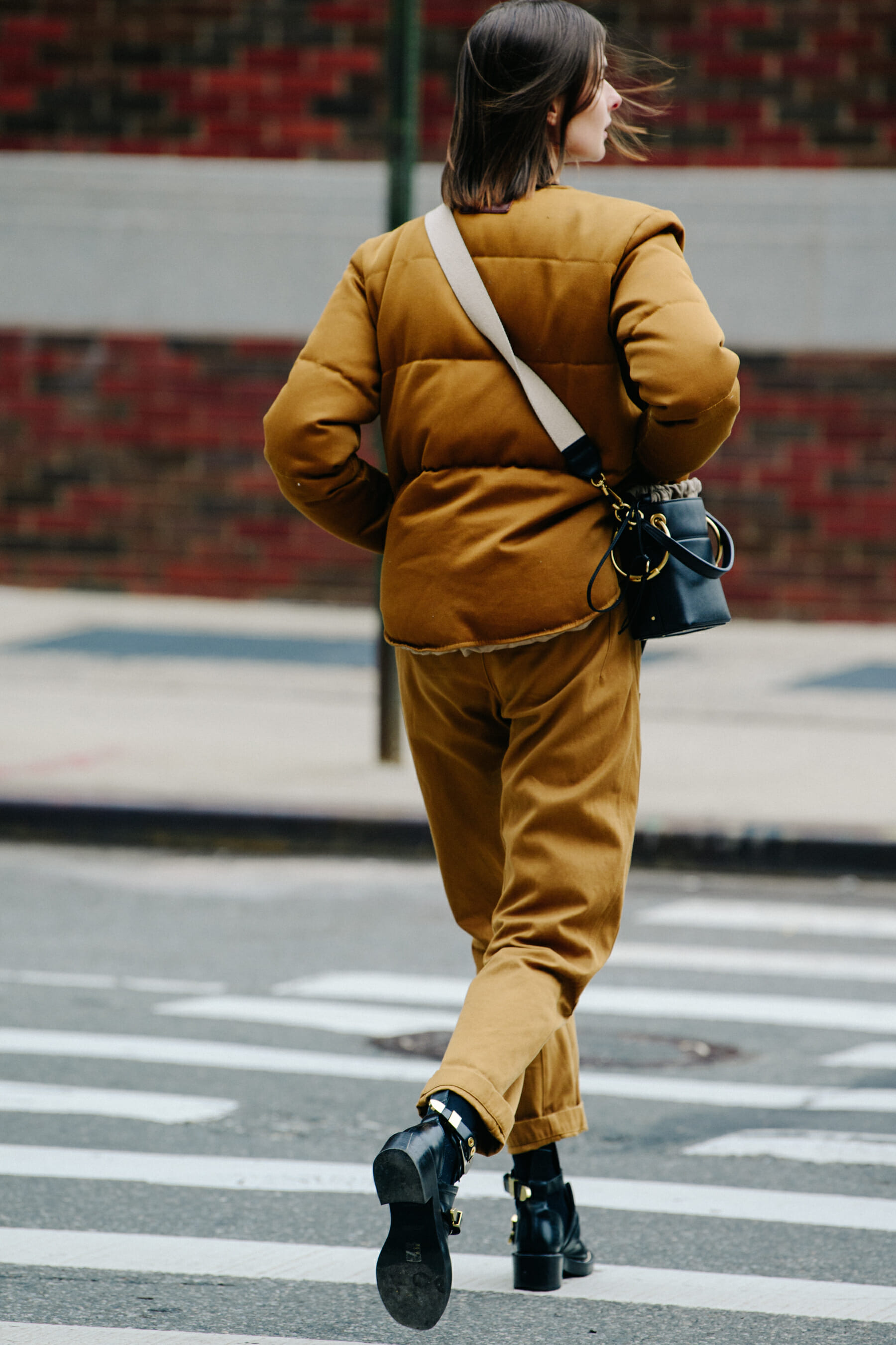 Model wearing brown outfit