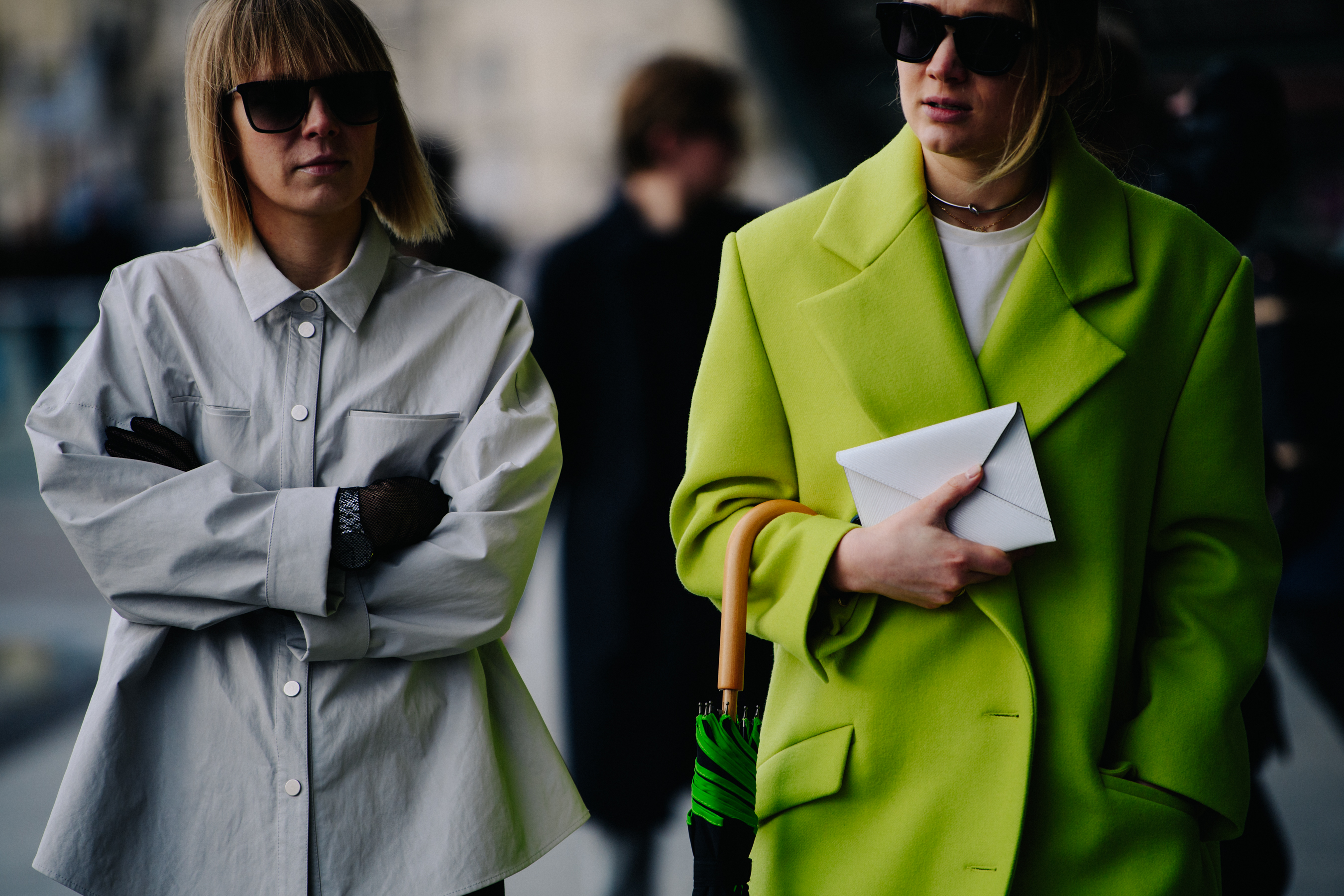Two women wearing grey and green