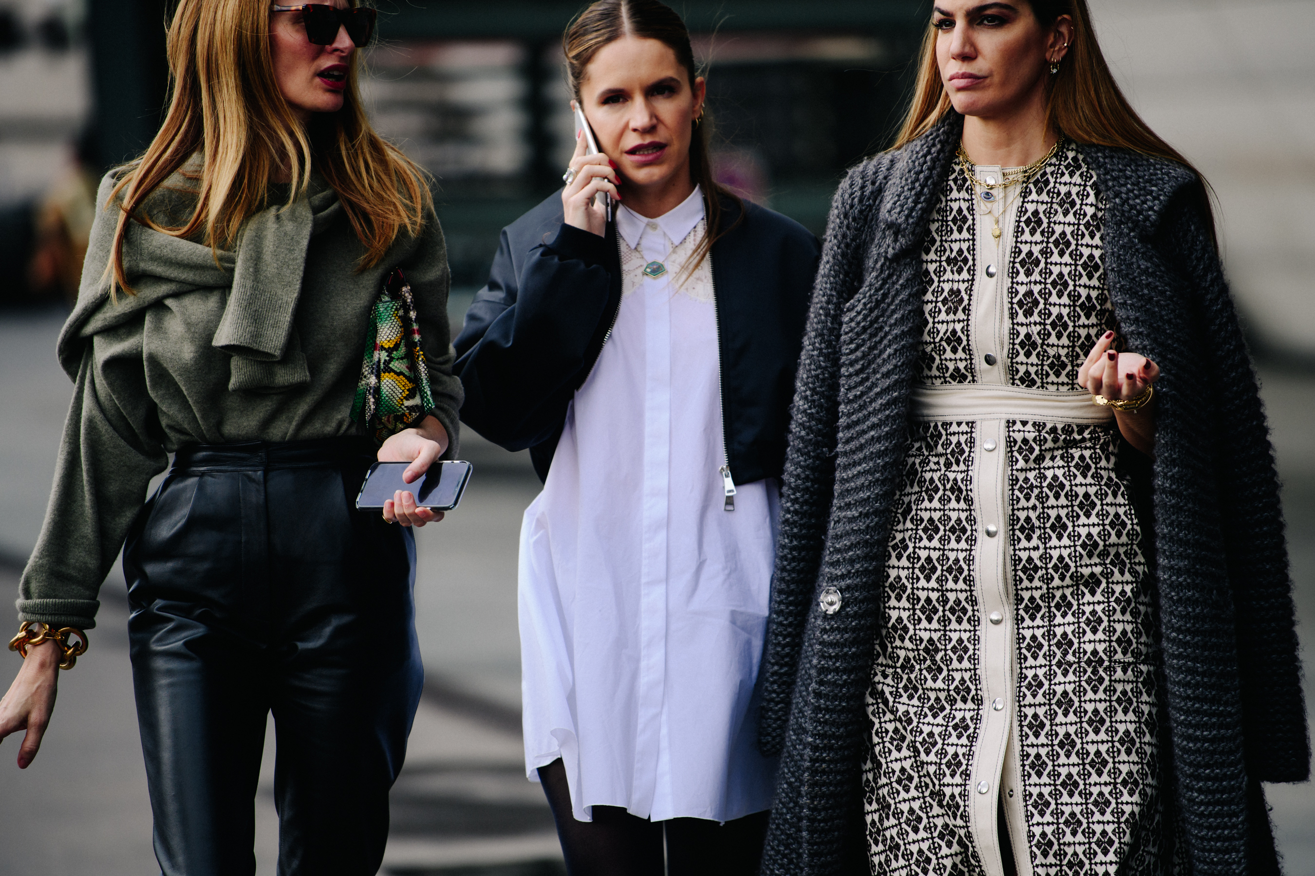 Three women wearing stylish outfits