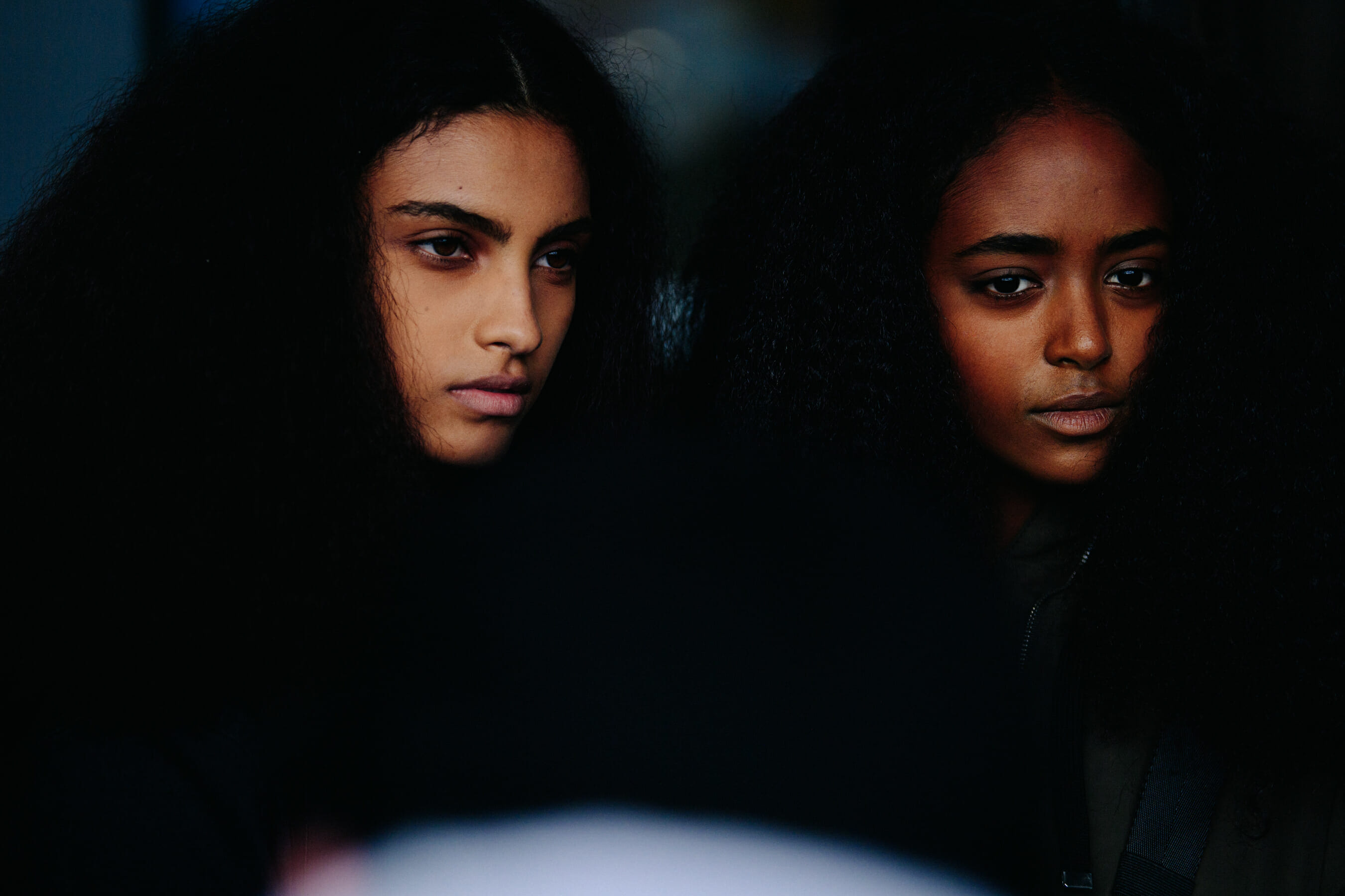 Two models with curly hair