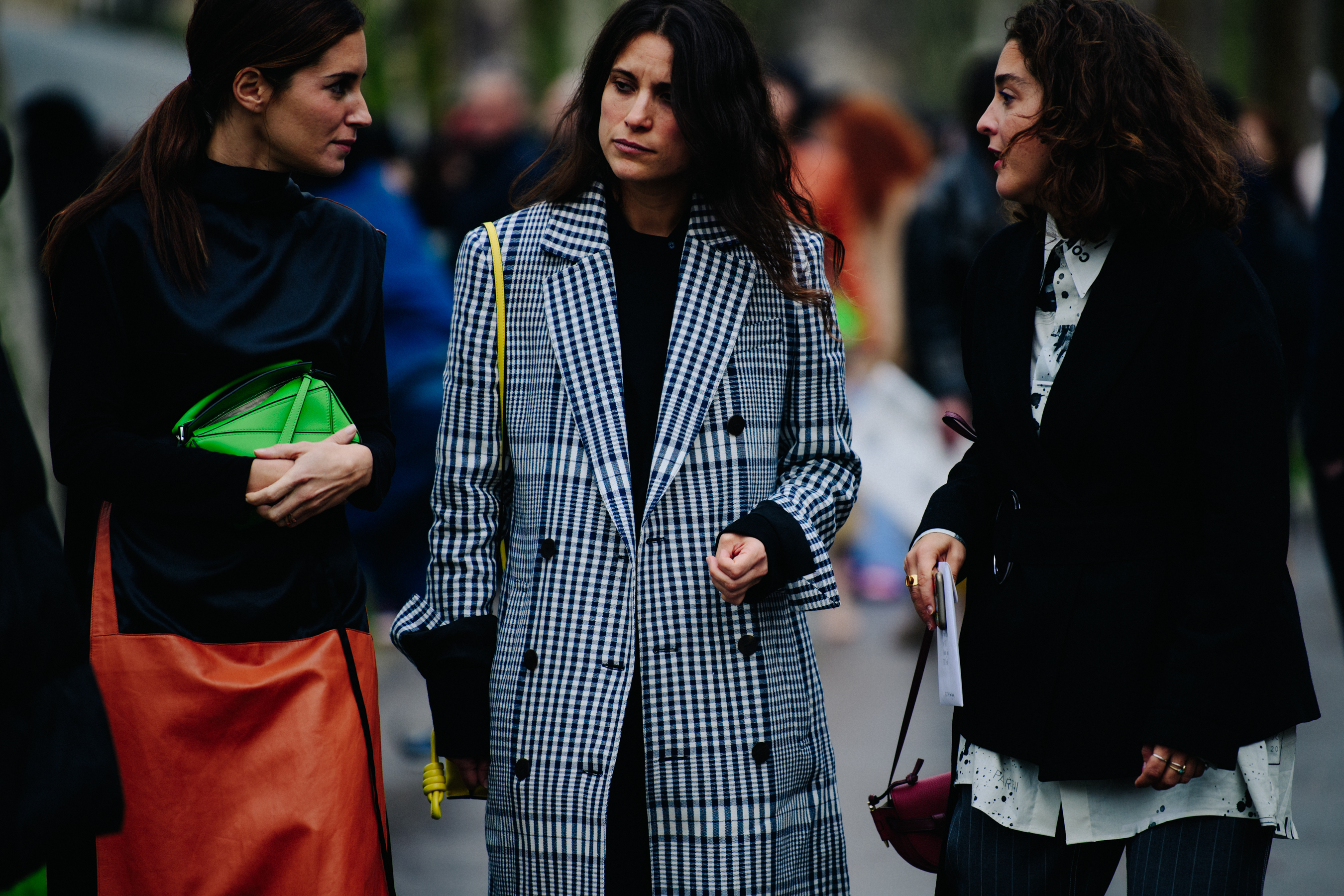Three women wearing dark jackets