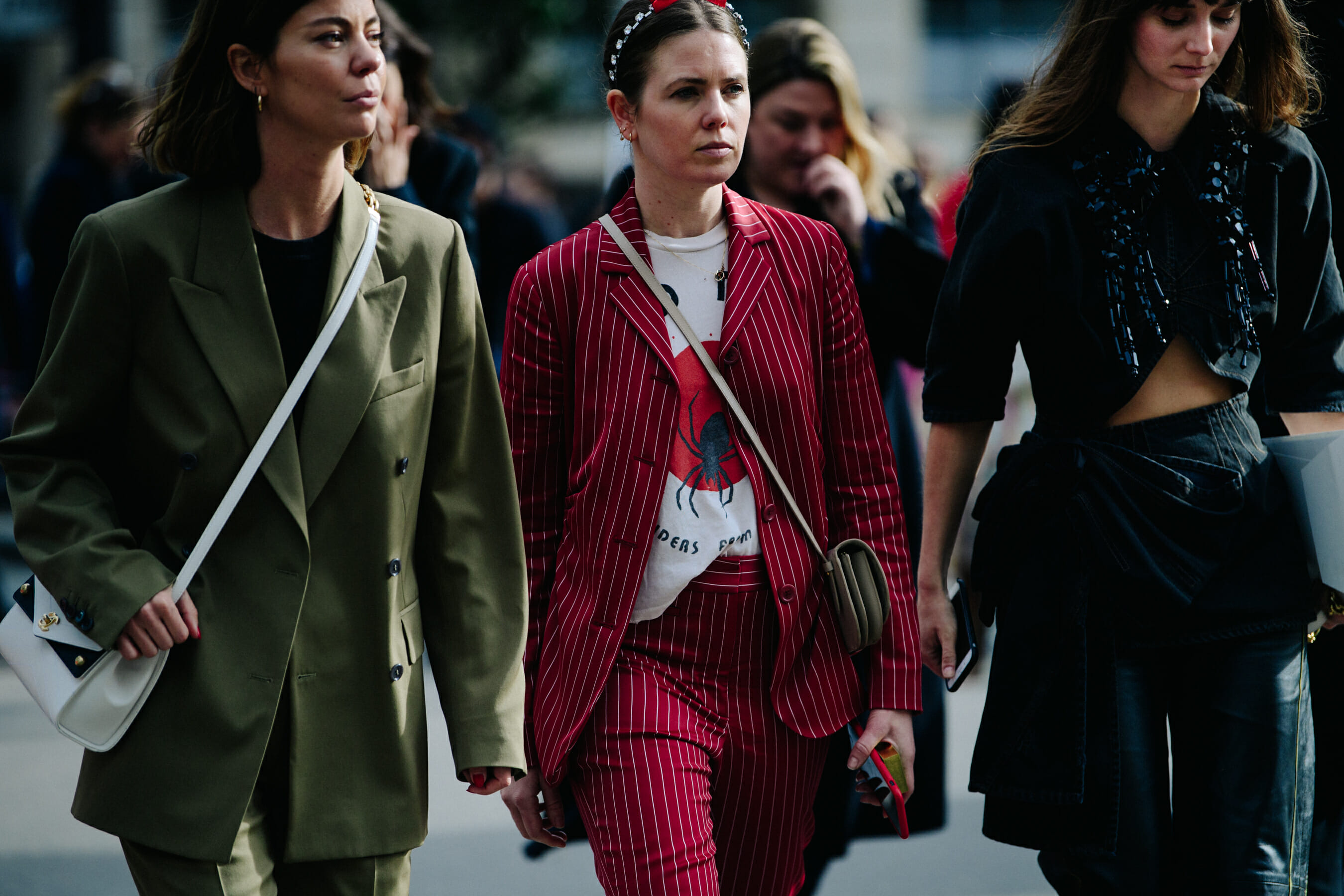 Three women wearing stylish outfits