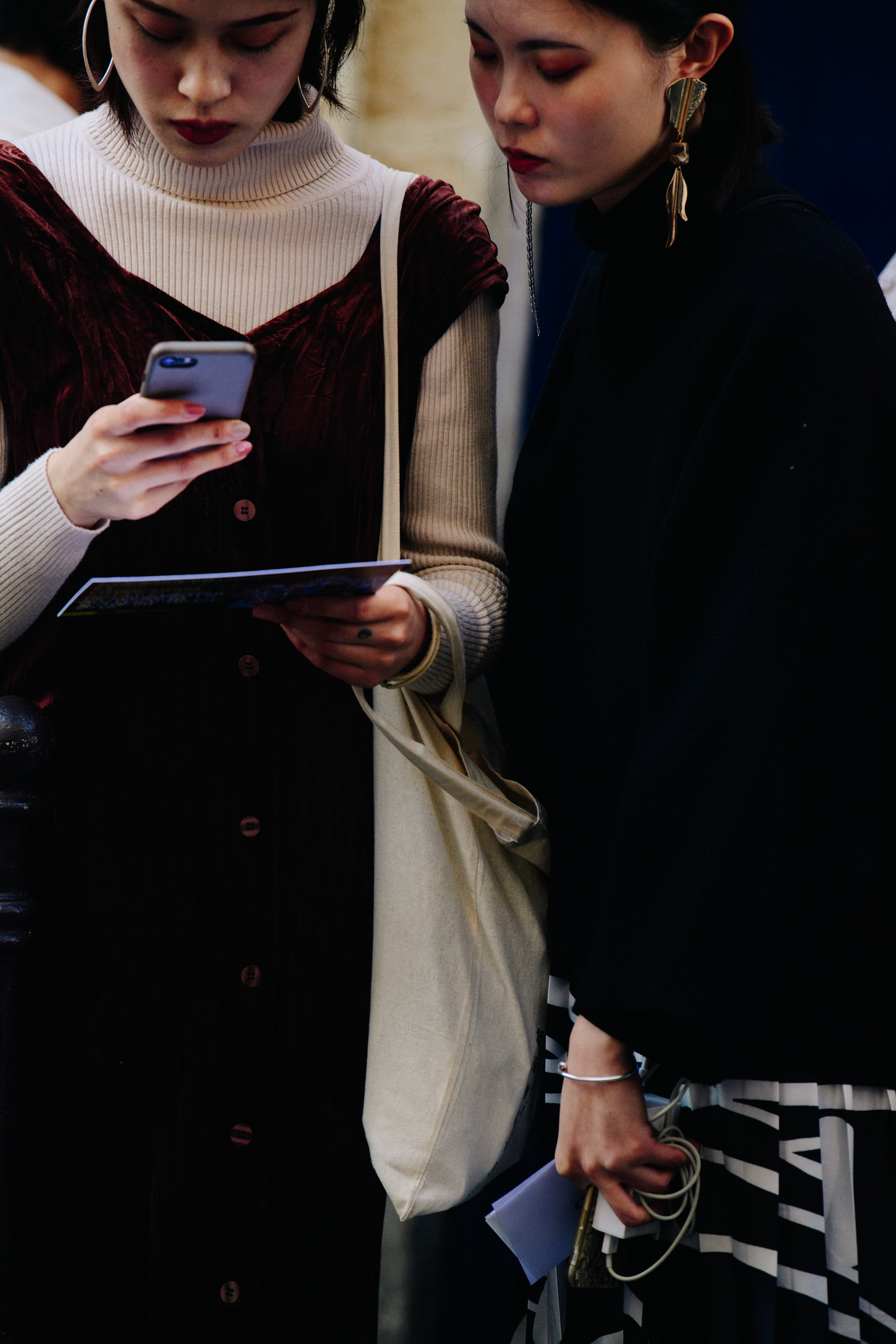 Two women wearing dark outfits