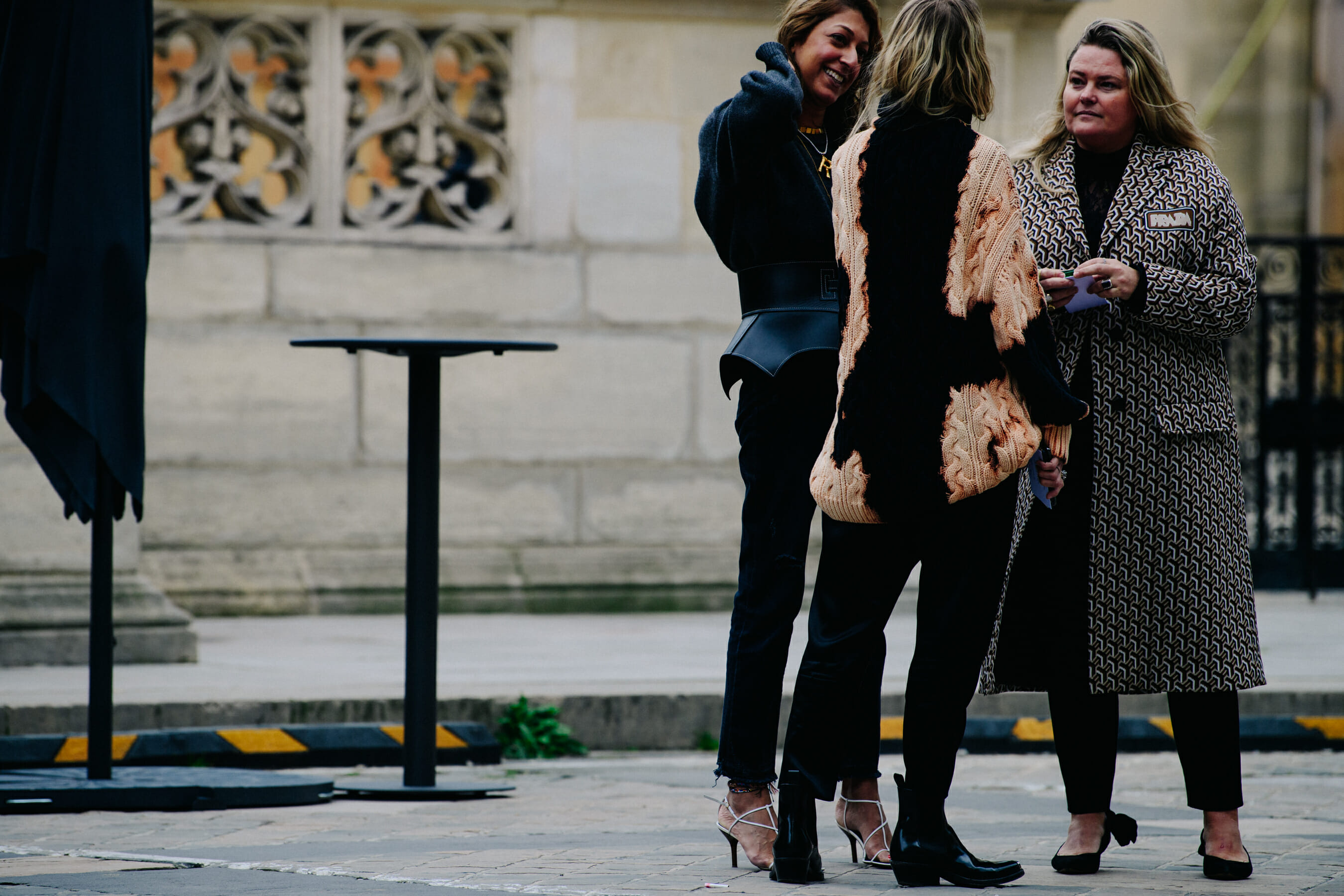 Three women waiting outside show
