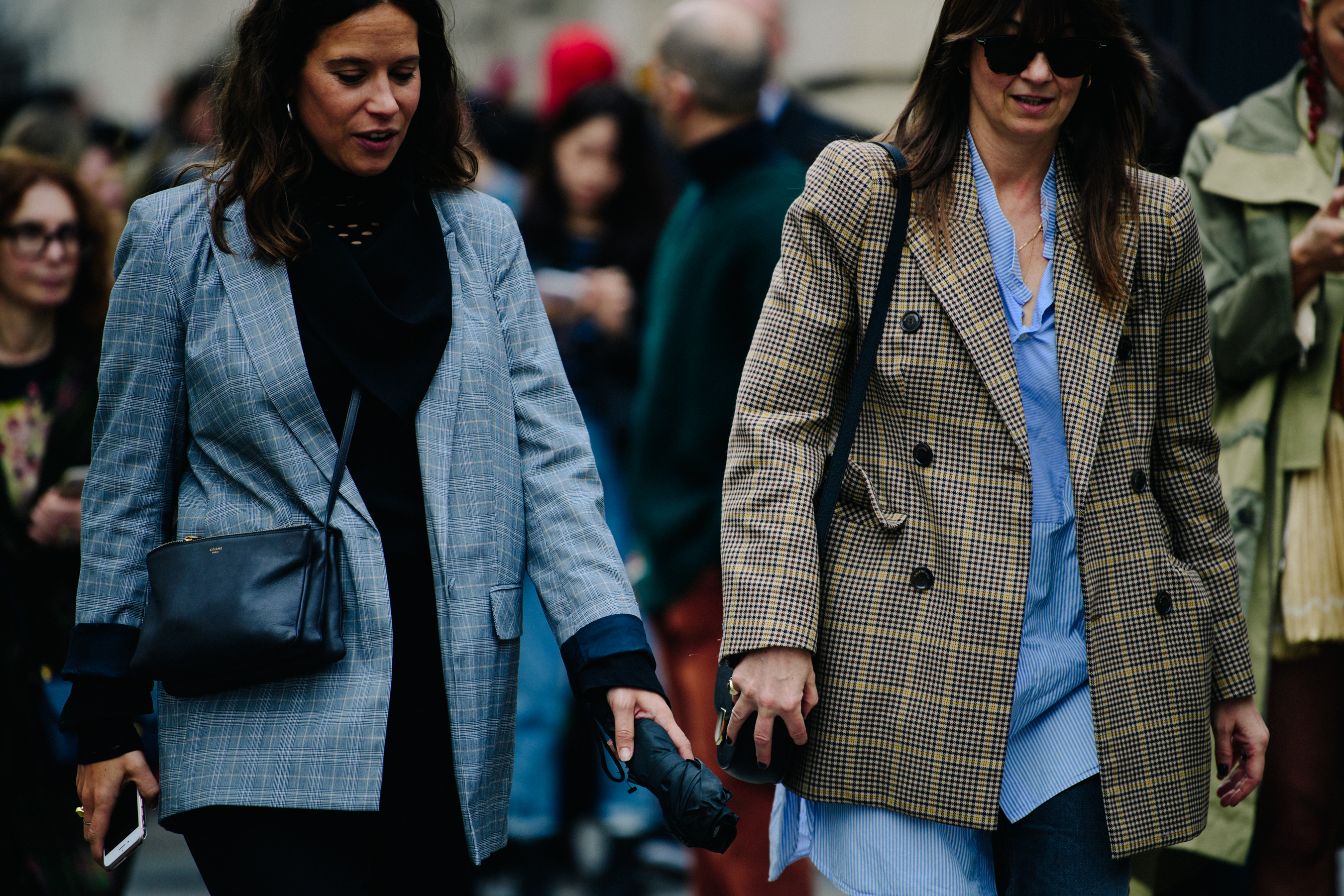 Two women wearing check jackets