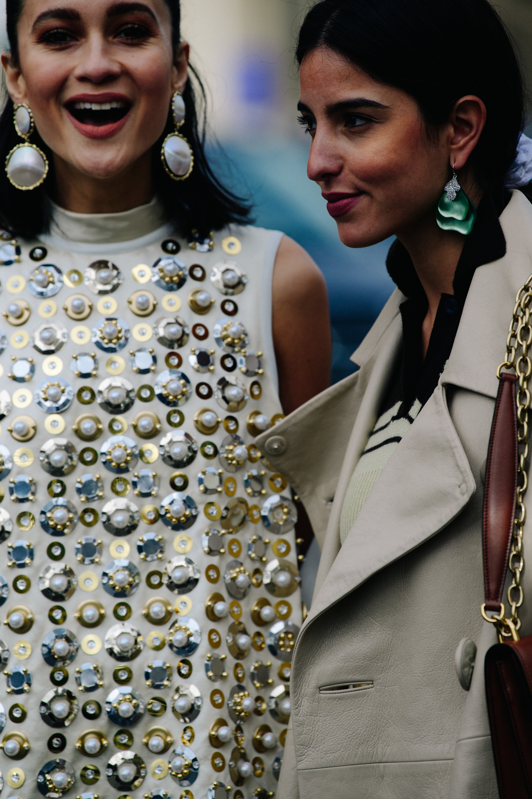 Two women wearing tan outfits