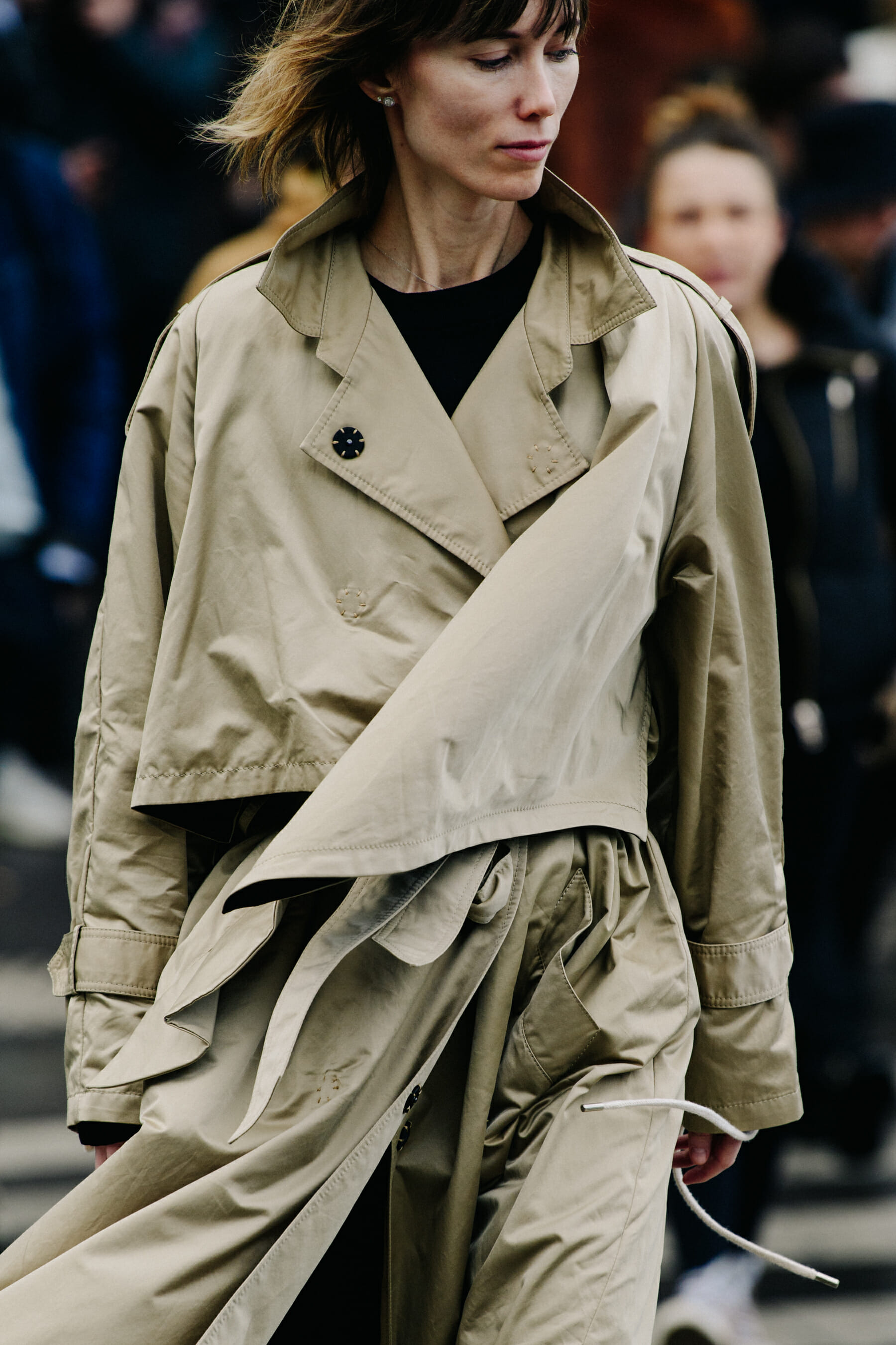 Woman wearing long tan coat