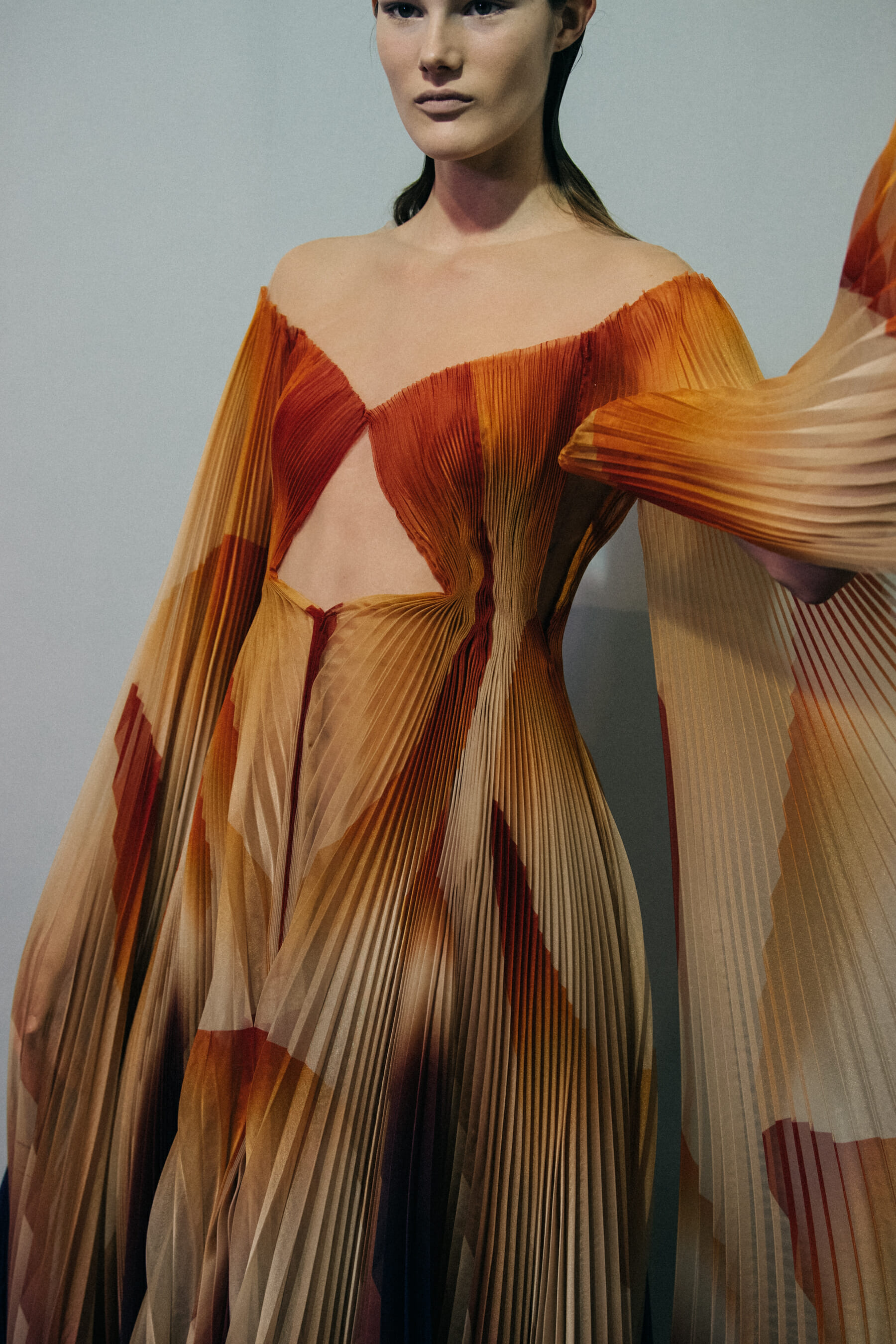 Model wearing orange Iris van Herpen dress