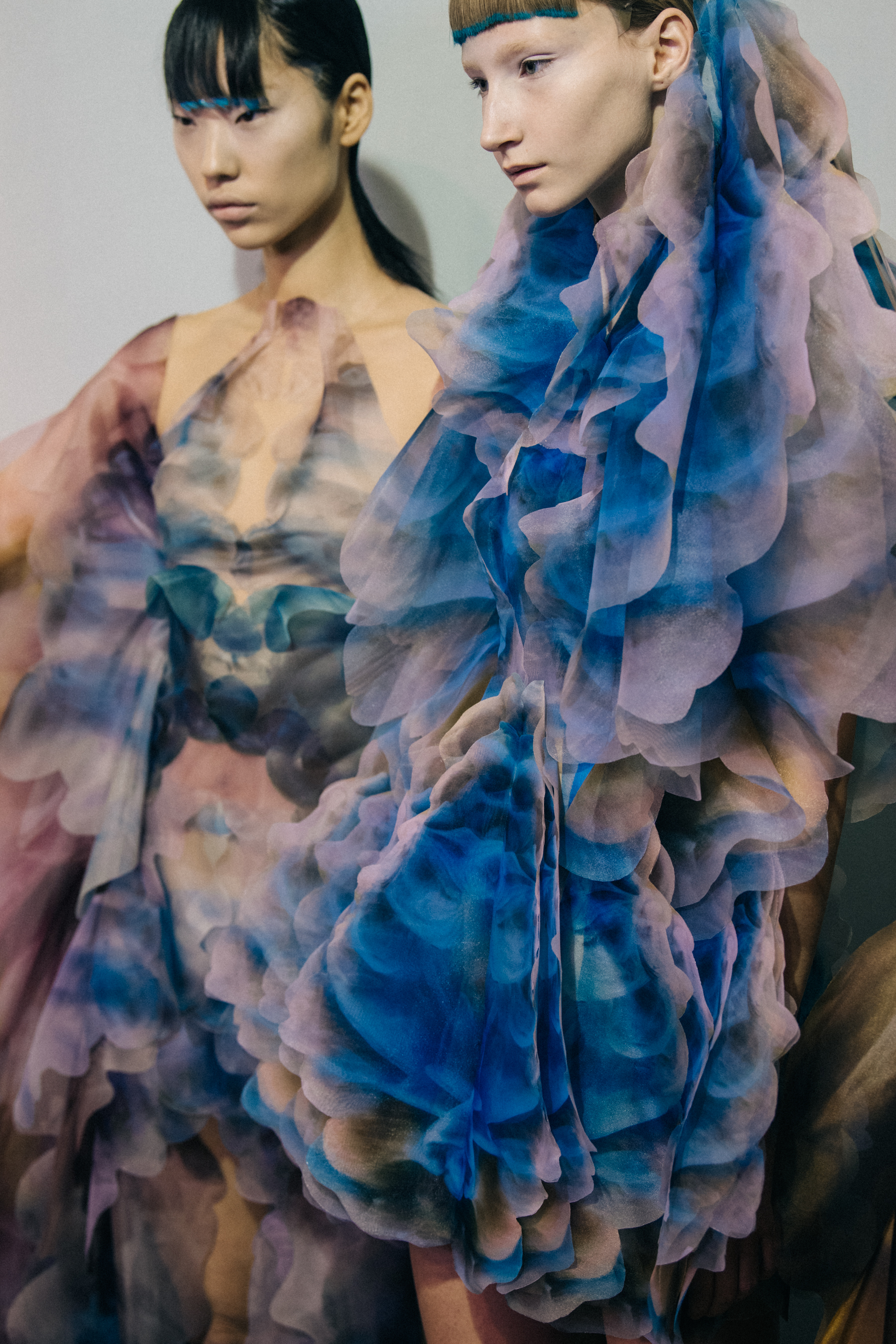 Models wearing colourful dresses at Iris van Herpen