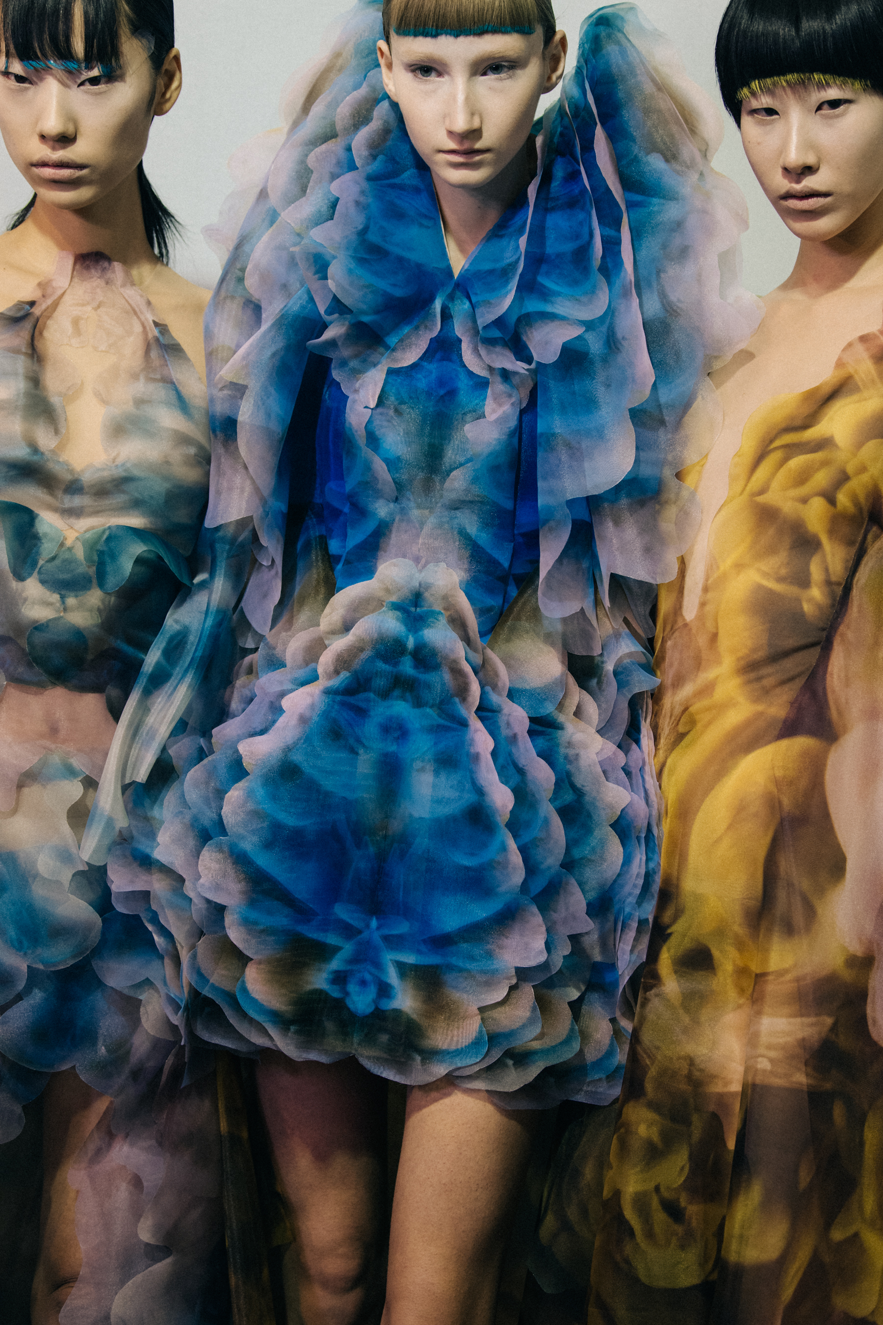 Models wearing colourful dresses at Iris van Herpen