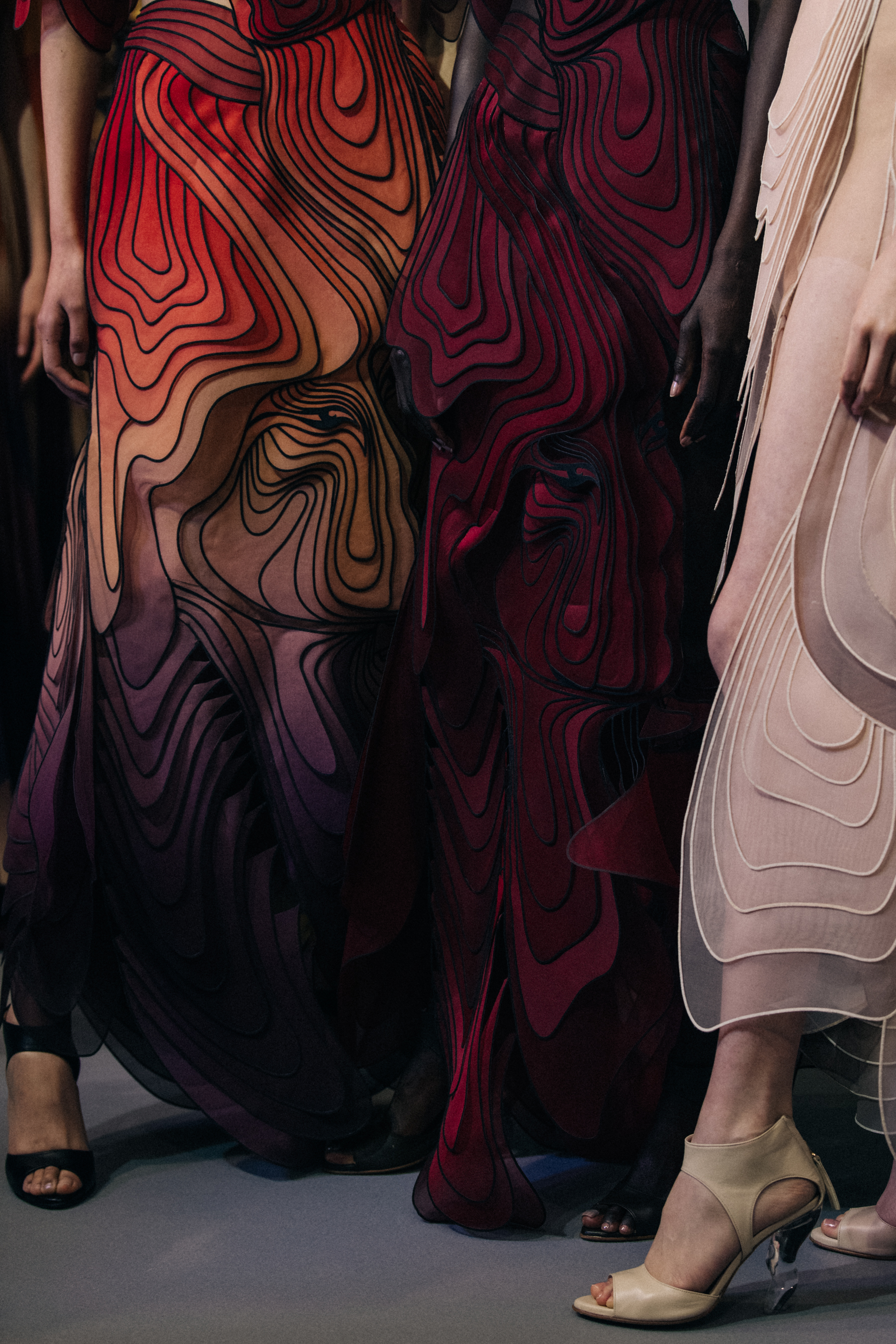 Models wearing colourful dresses at Iris van Herpen