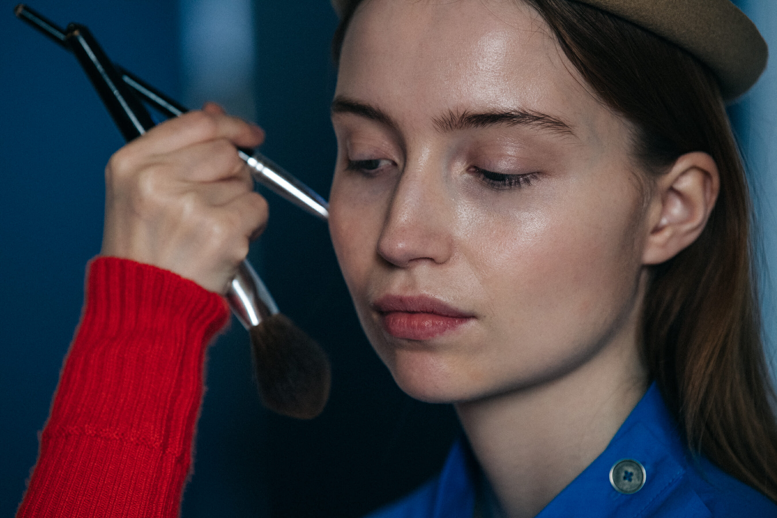 Model wearing blue backstage at Nehera