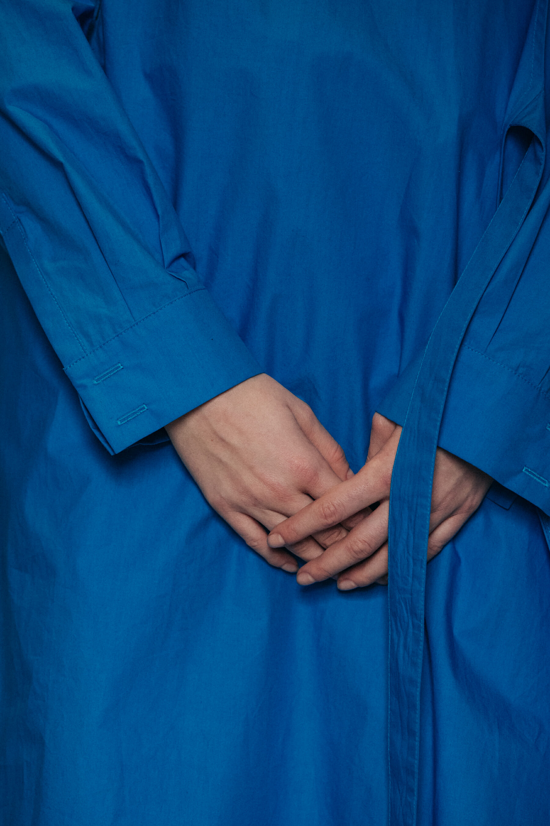 Model wearing blue backstage at Nehera
