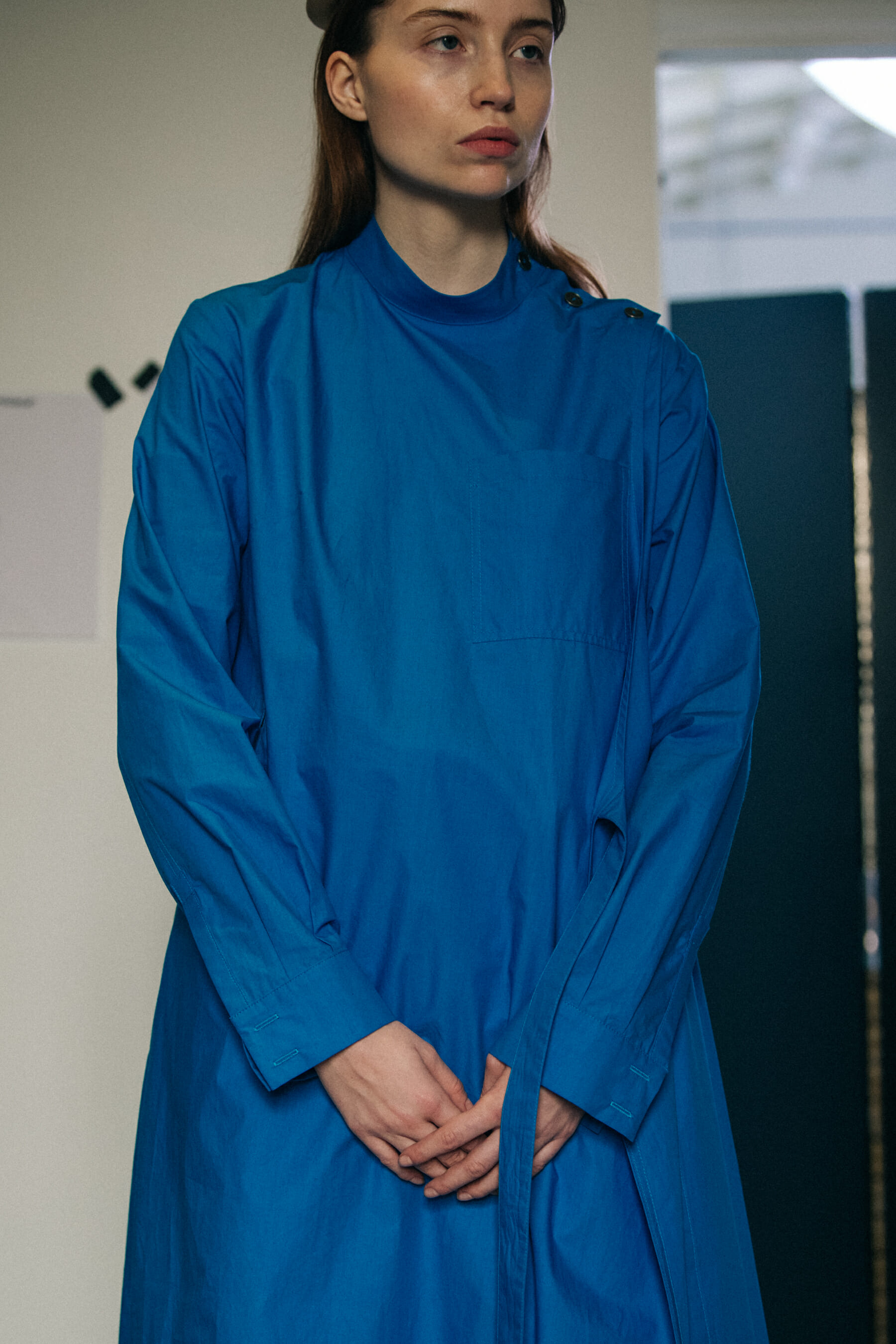 Model wearing blue backstage at Nehera