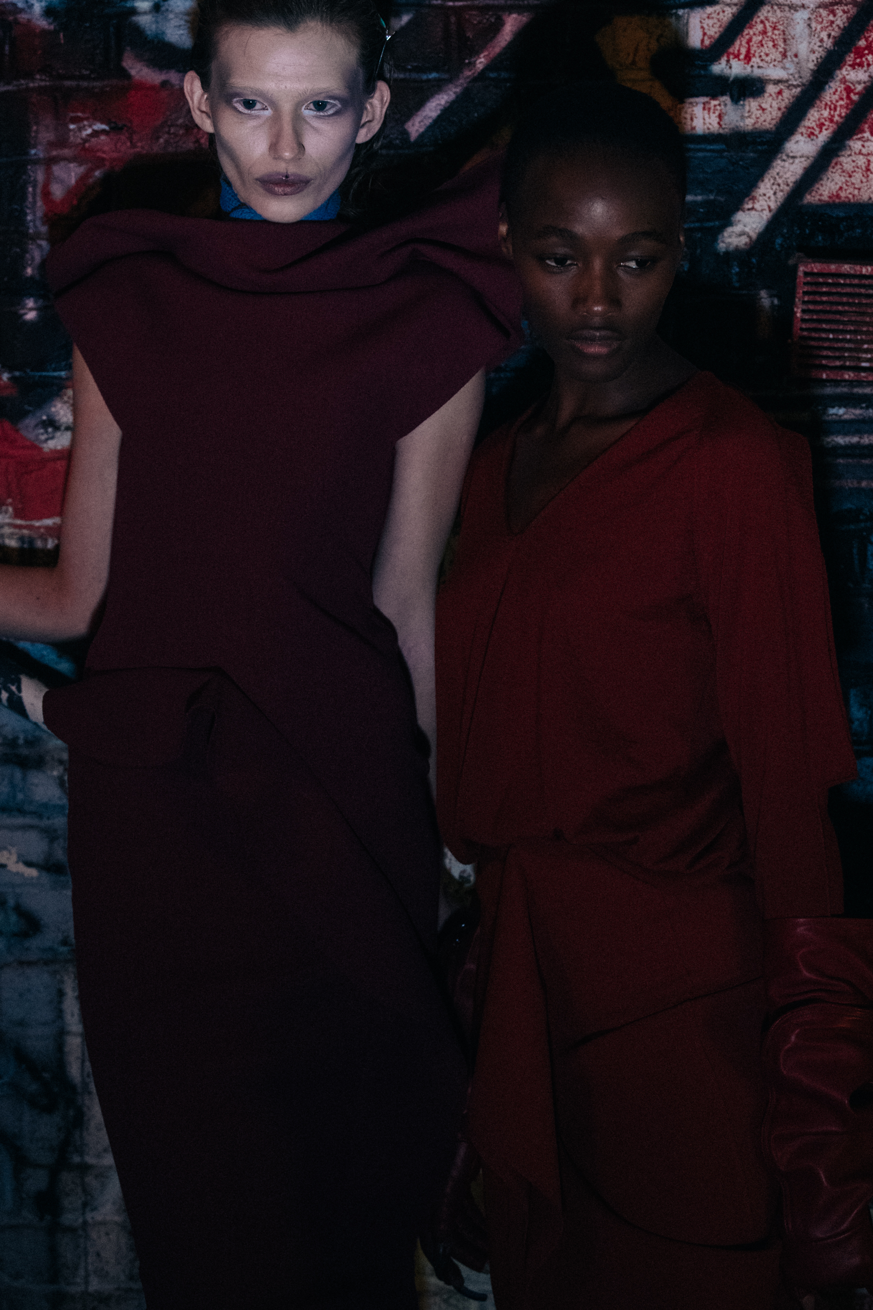 Two models wearing red dresses
