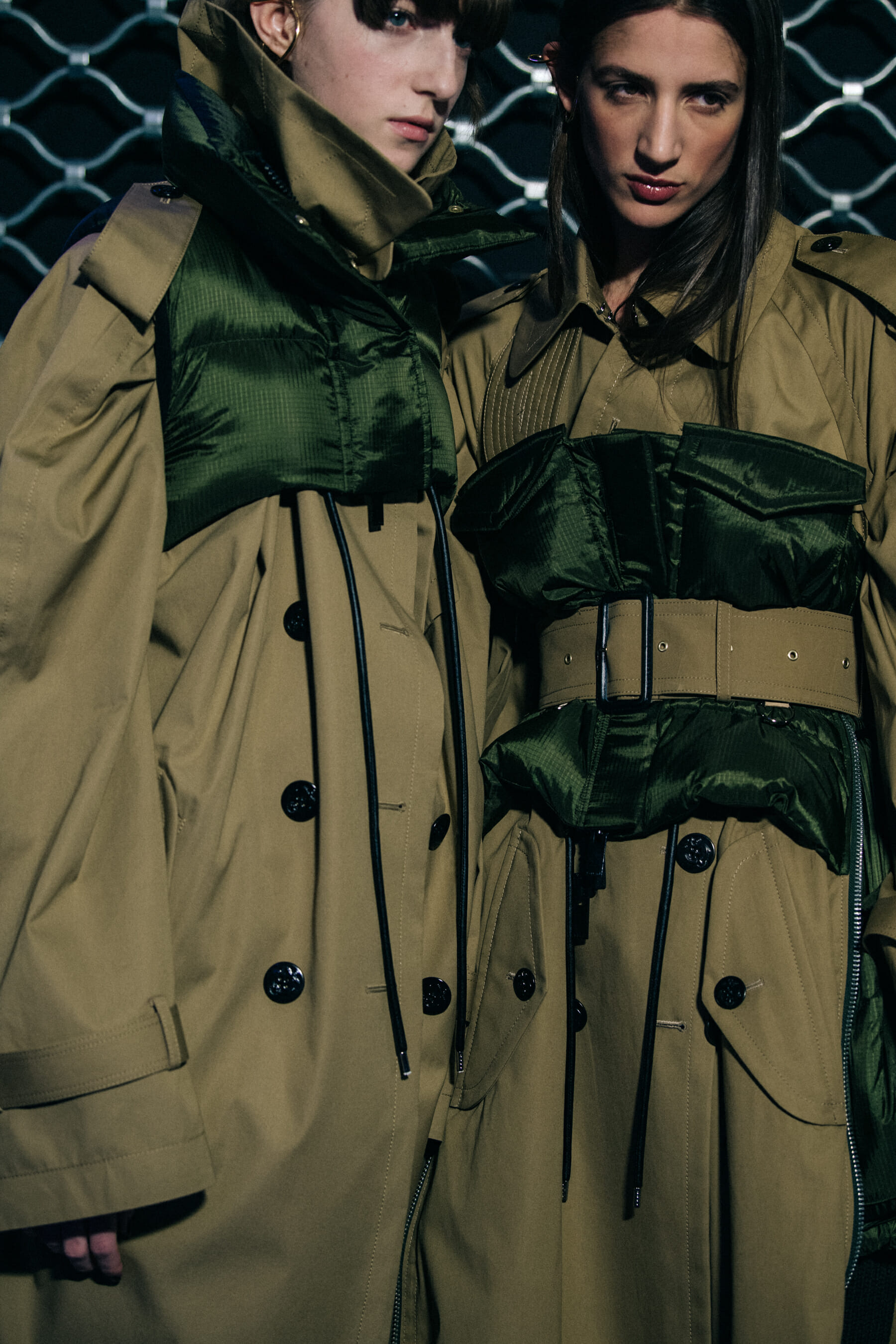 Models wearing trench coats at Sacai