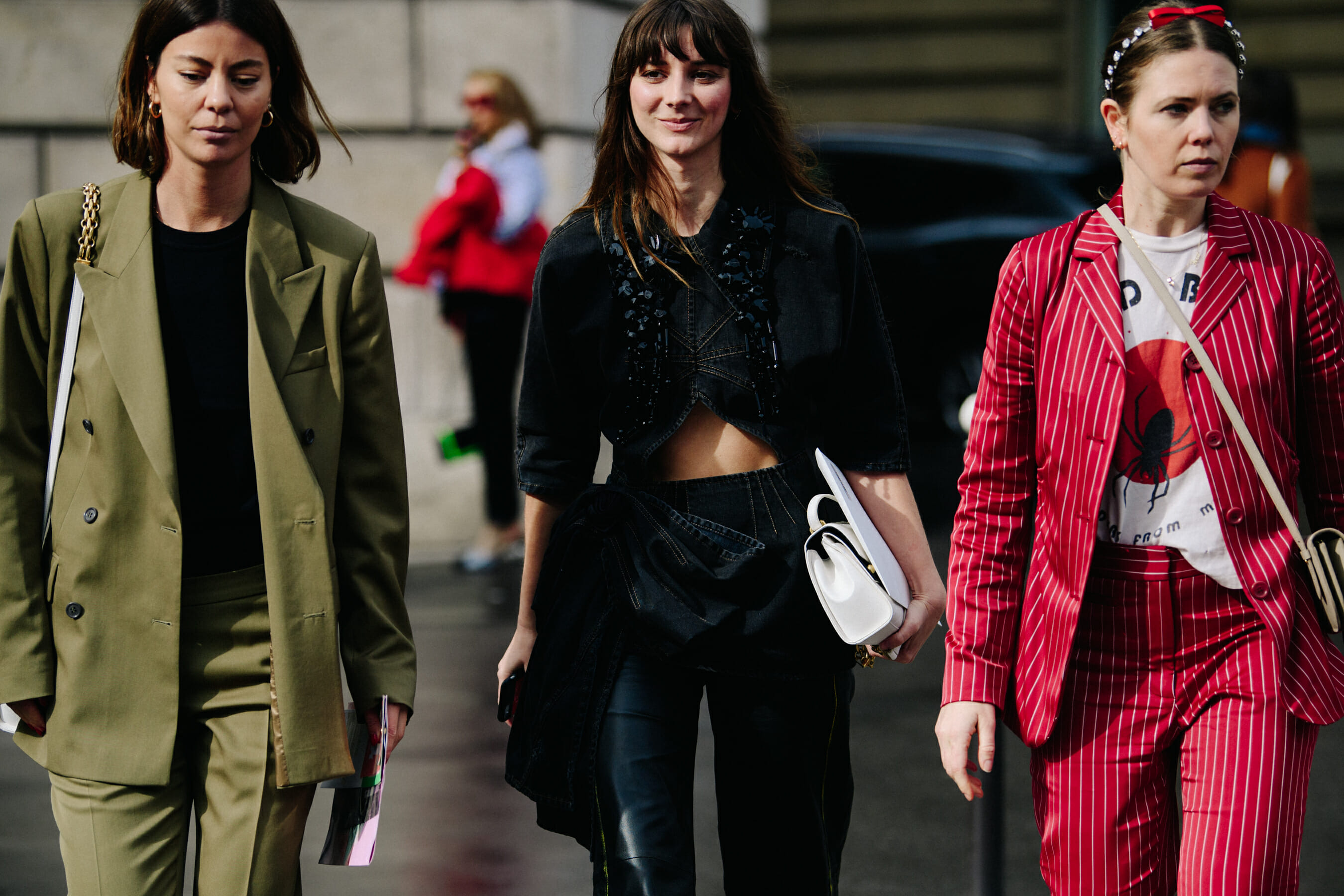 Three women wearing colourful outfits