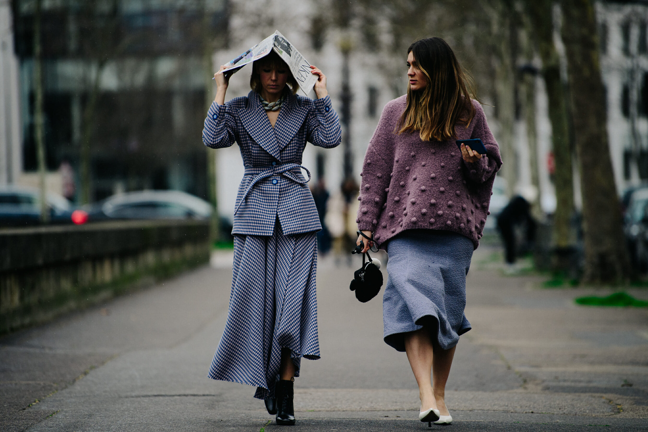 Two women wearing purple