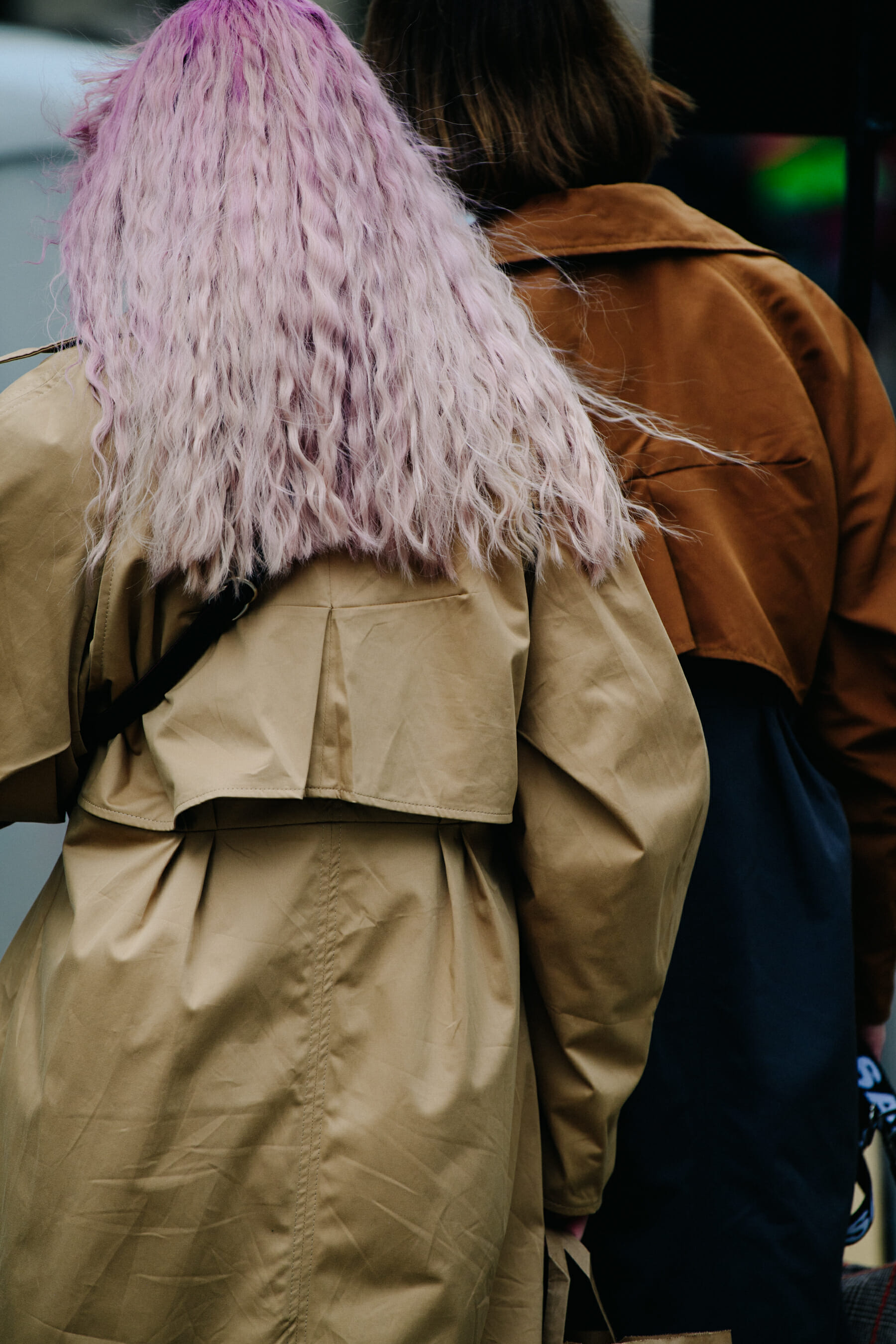 Two women wearing tan coats