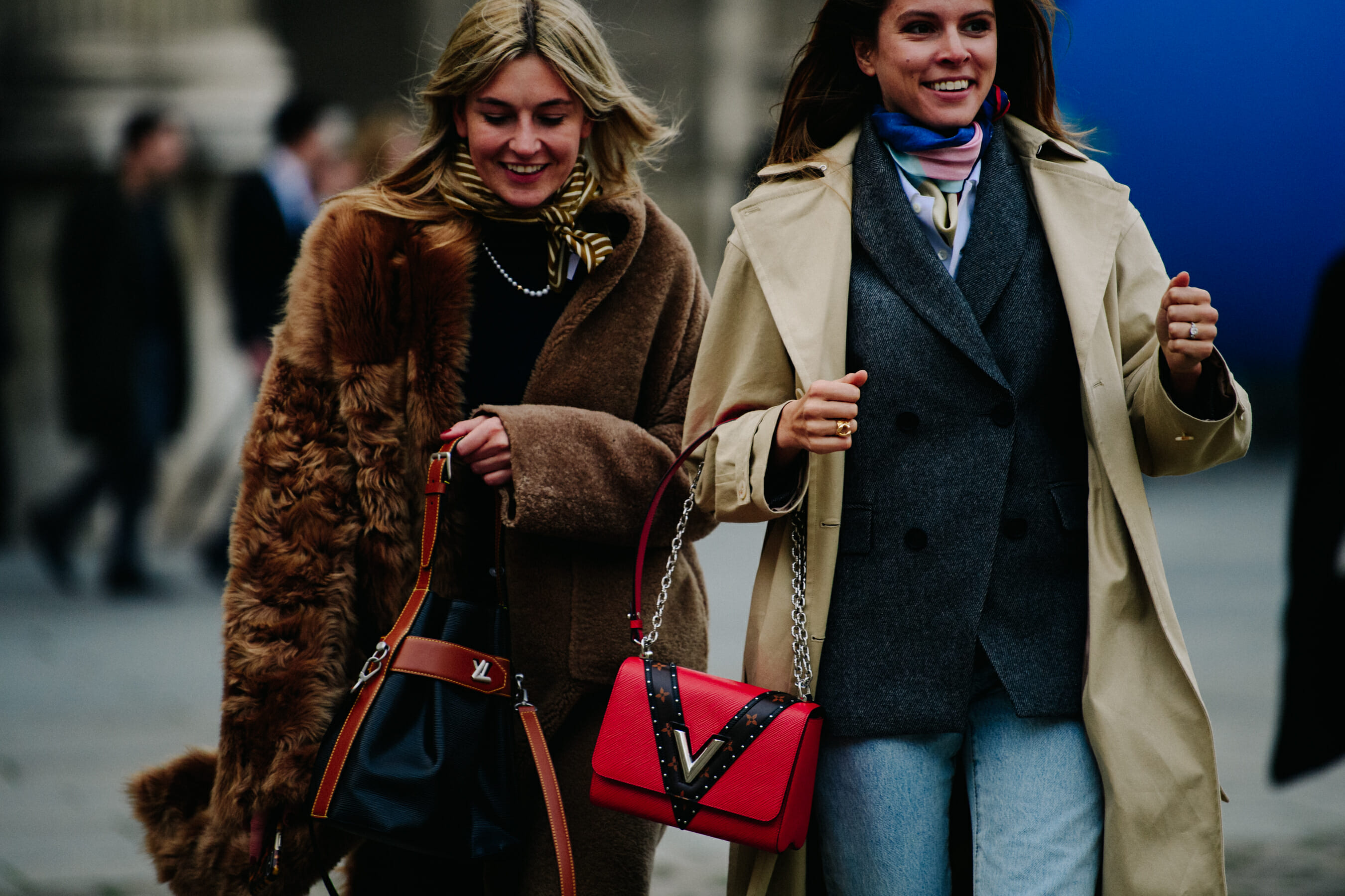 Two women carrying Louis Vuitton bags