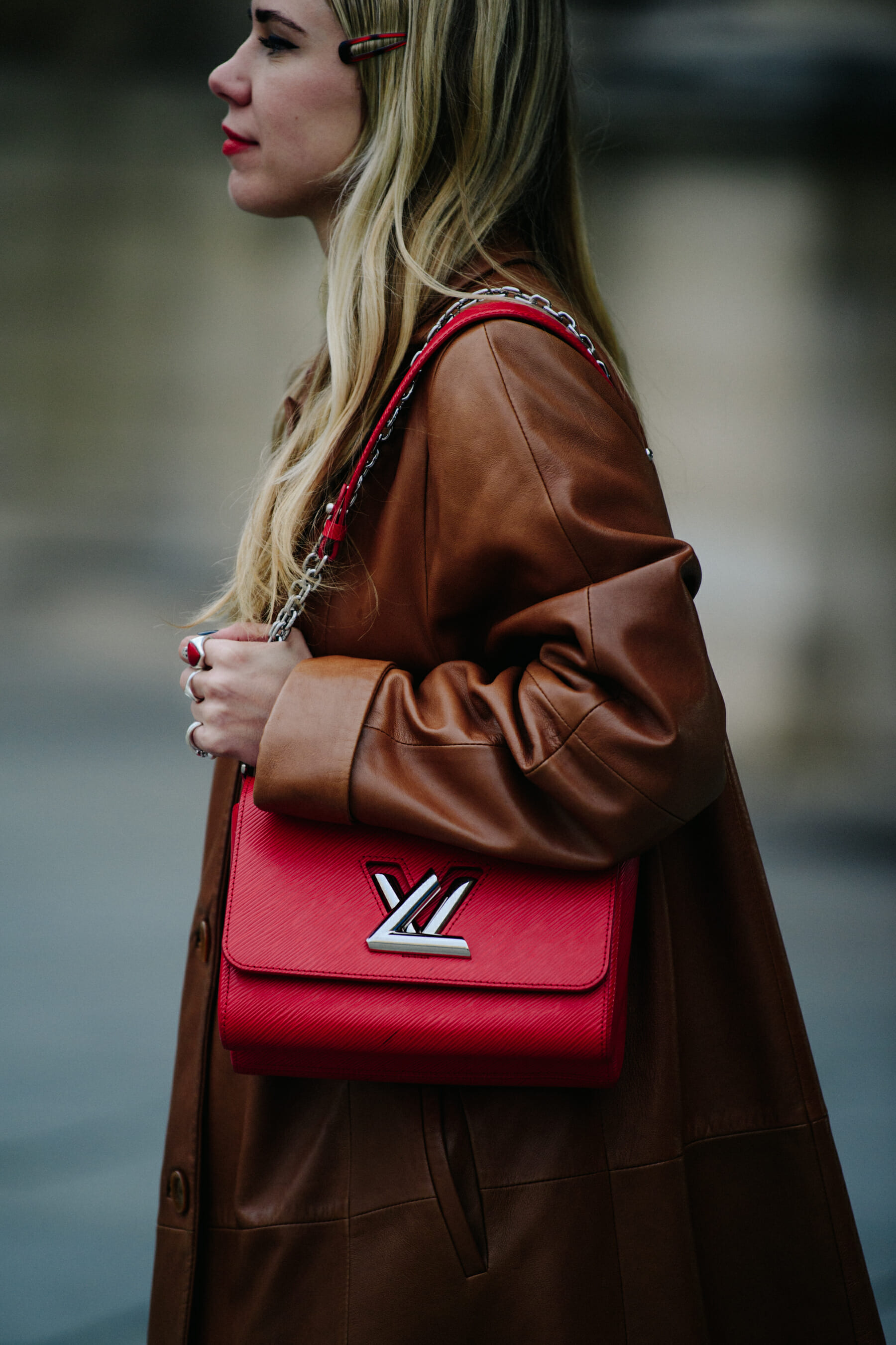 Woman carrying red Louis Vuitton bag