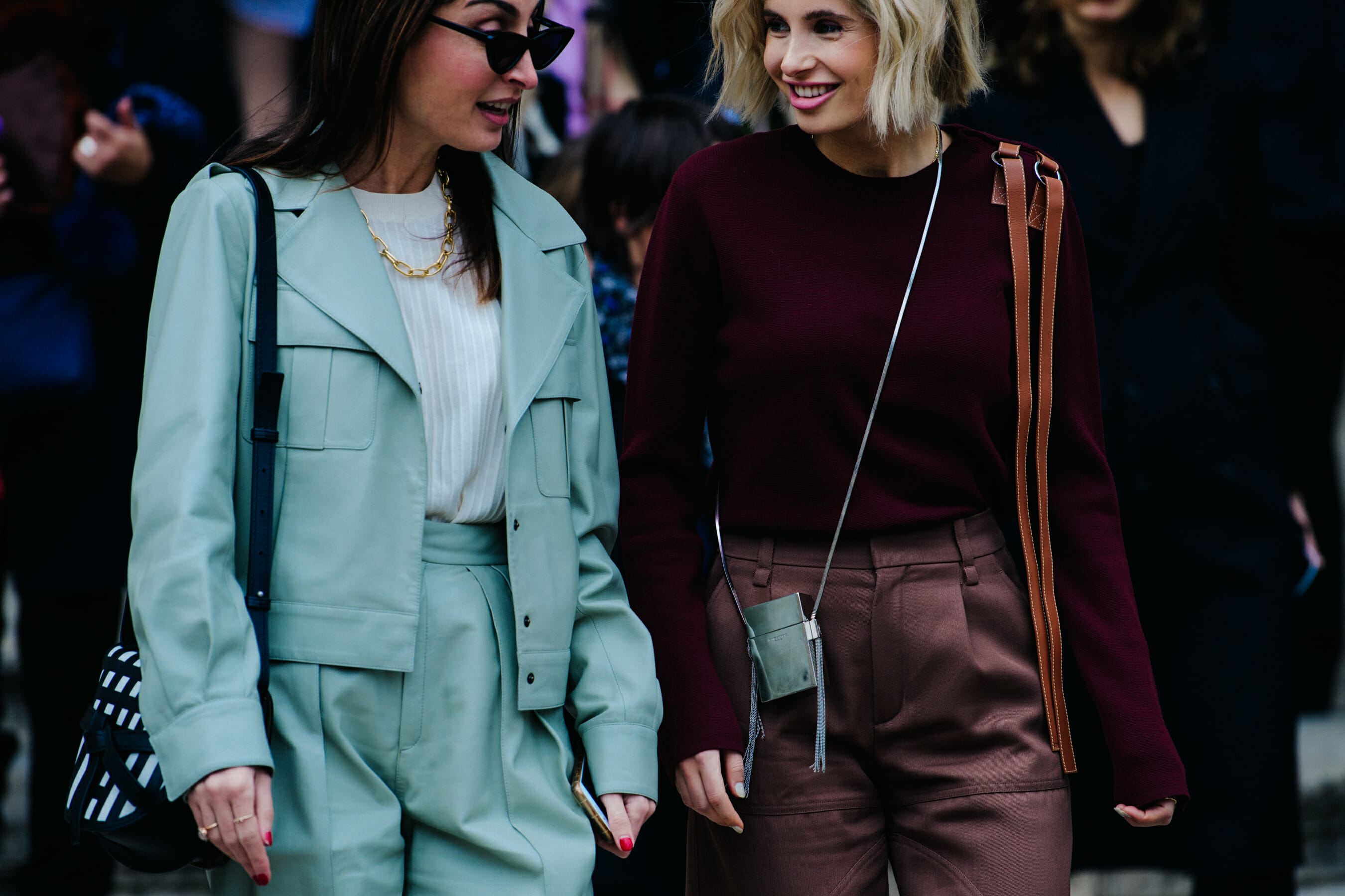 Two women wearing smart outfits