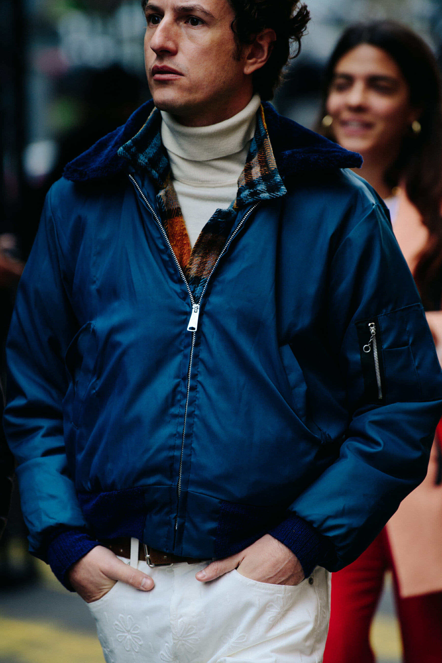 Man wearing blue bomber jacket