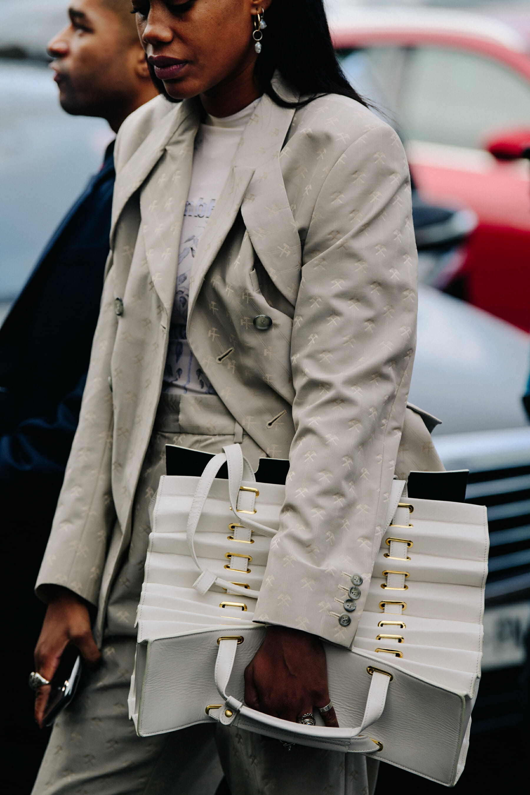 Woman carrying white leather bag