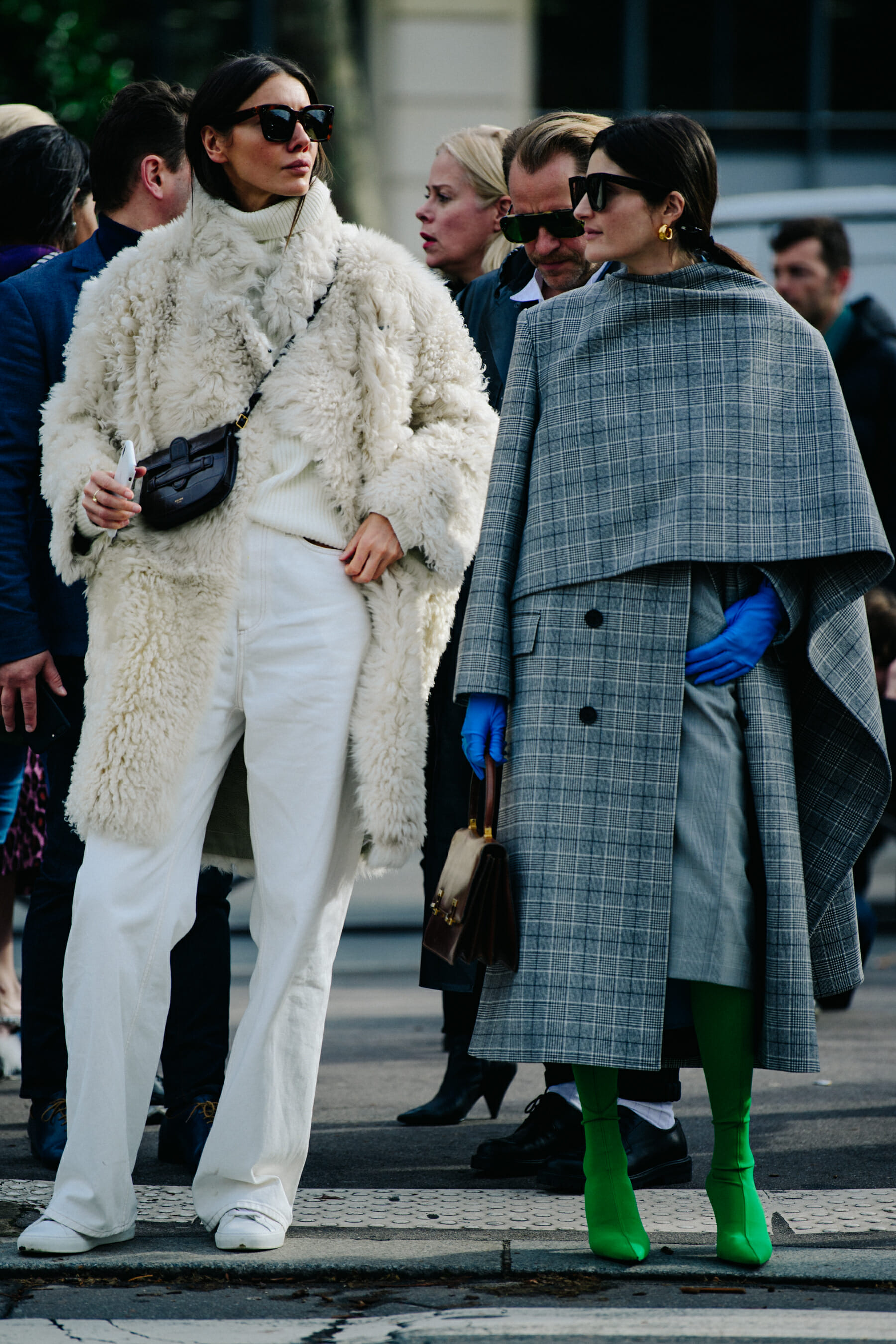 Two women wearing white and grey