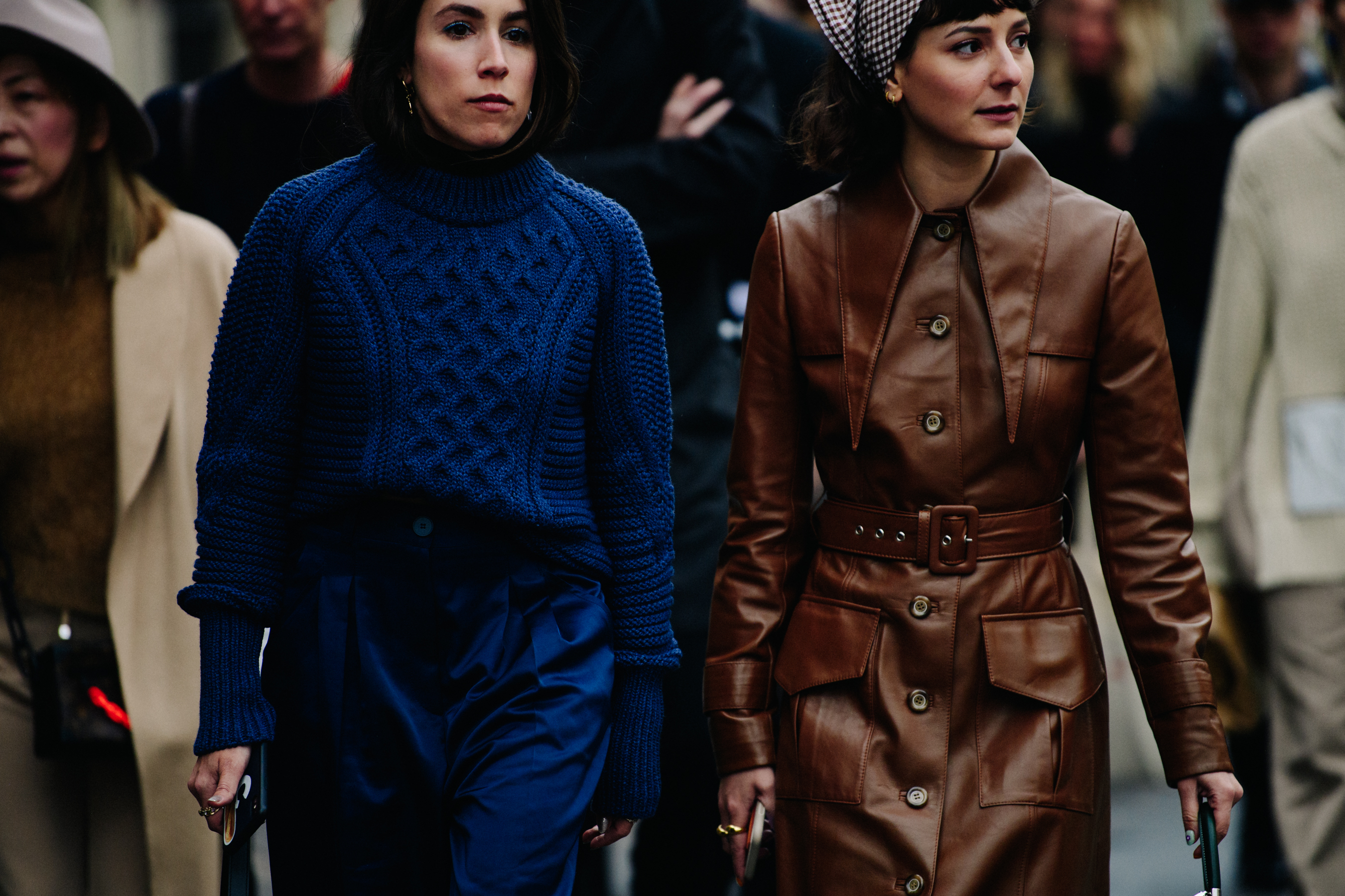 Two women wearing brown and blue